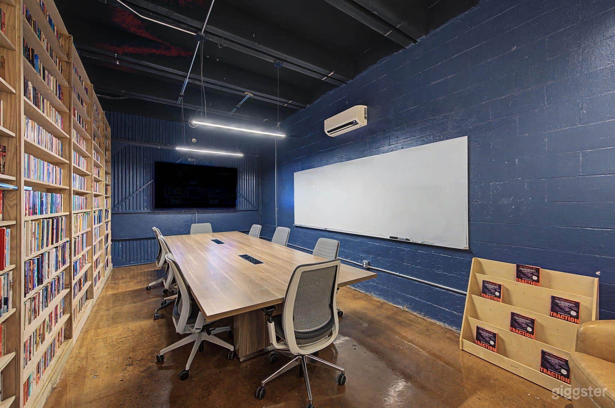 Library-Inspired Conference Room with Wall-to-Wall Books Photo 1