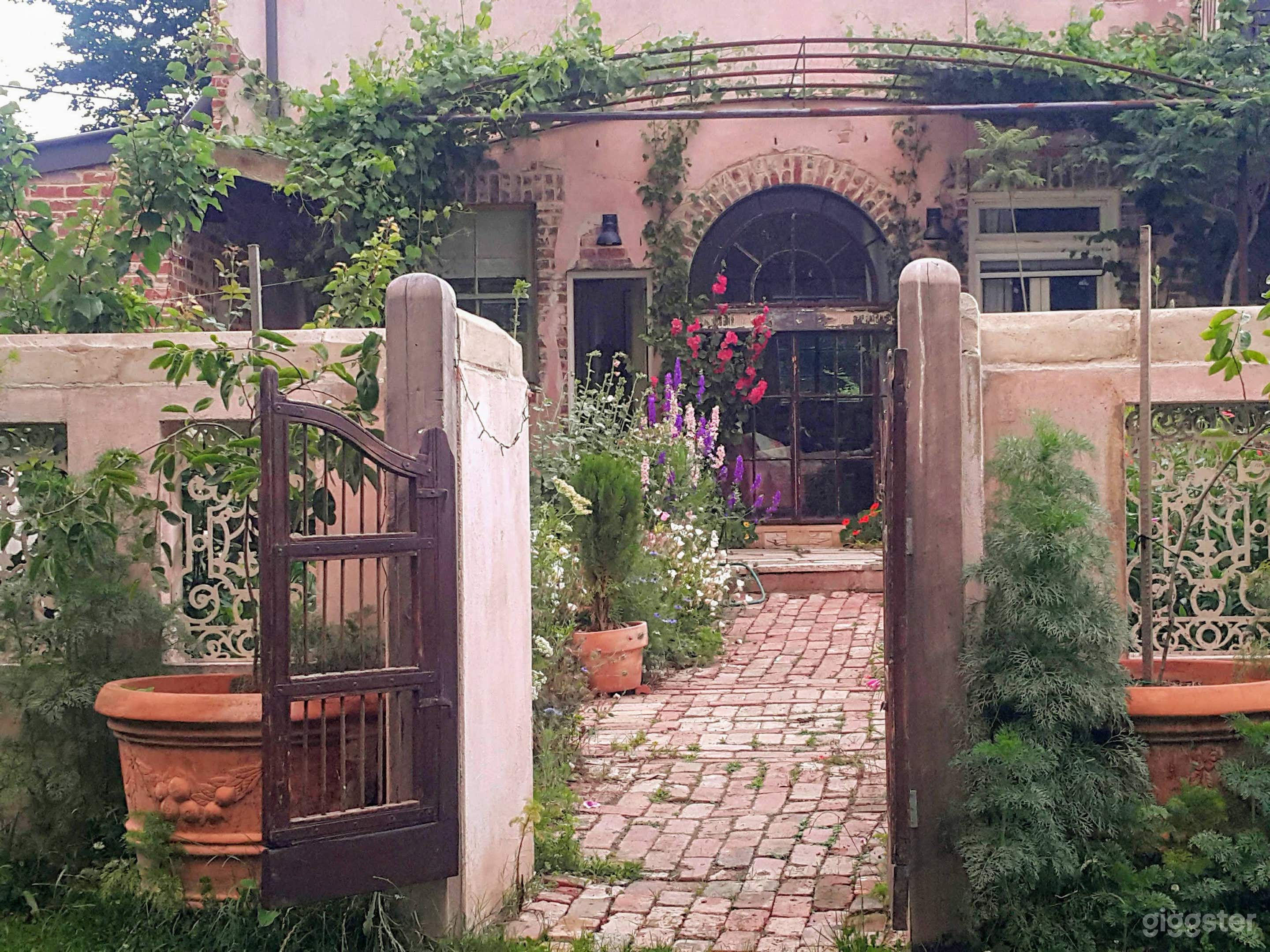 Courtyard, pink rendered walls, arched cast iron windows