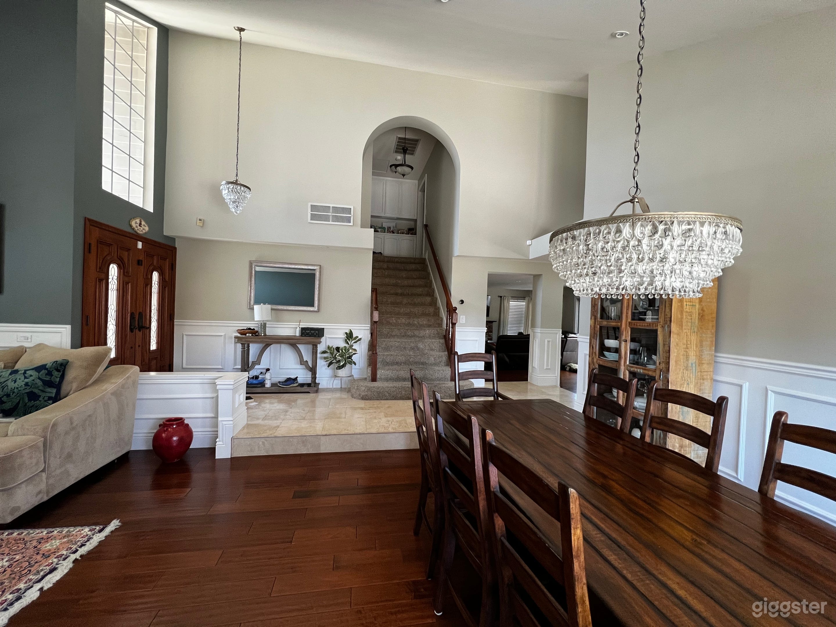 View of downstairs with large values ceilings and dining room