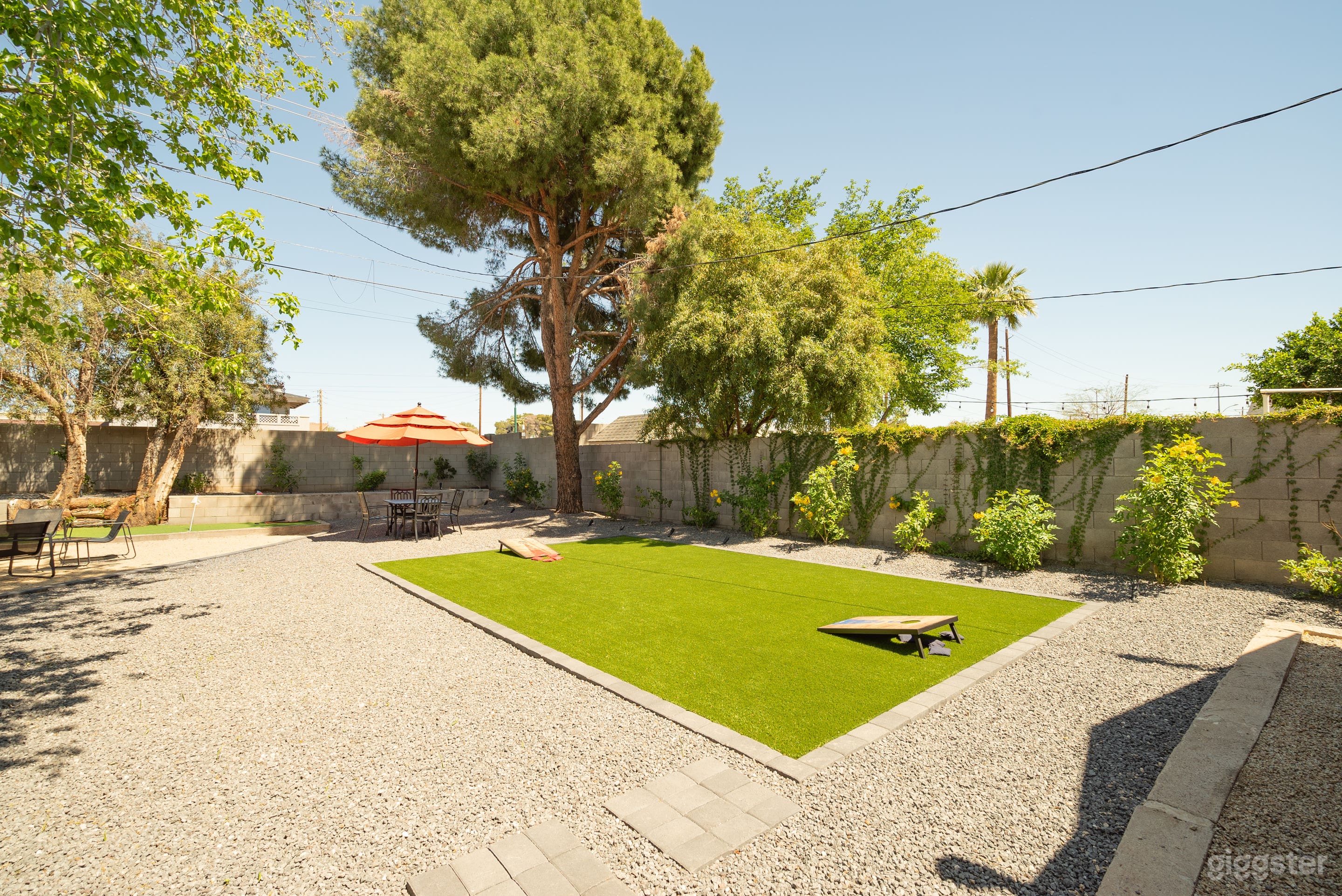 Beautiful backyard with turf, mini golf, BBQ propane grill, outdoor dining and seating.