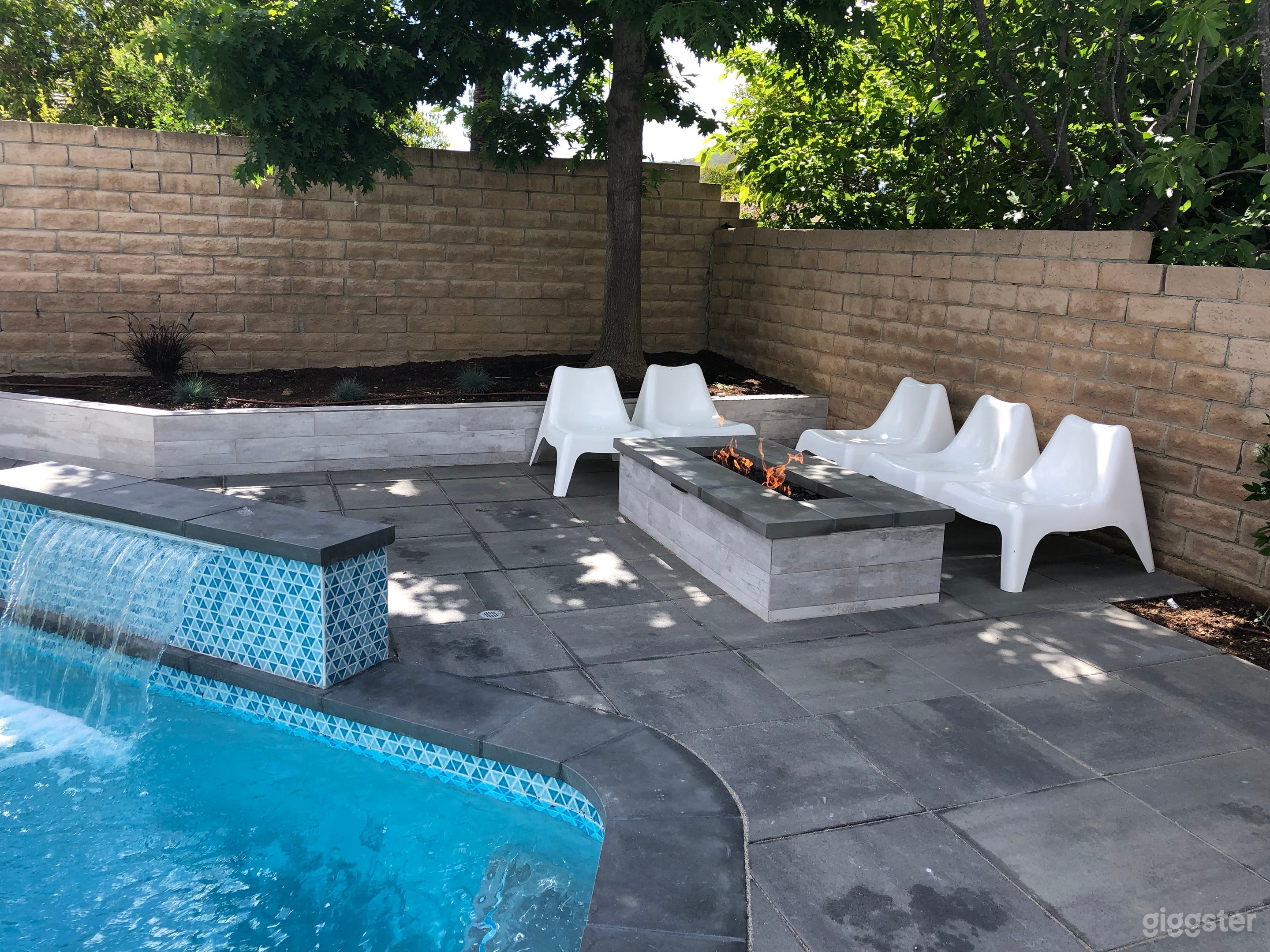 Pool waterfall feature and fire pit.