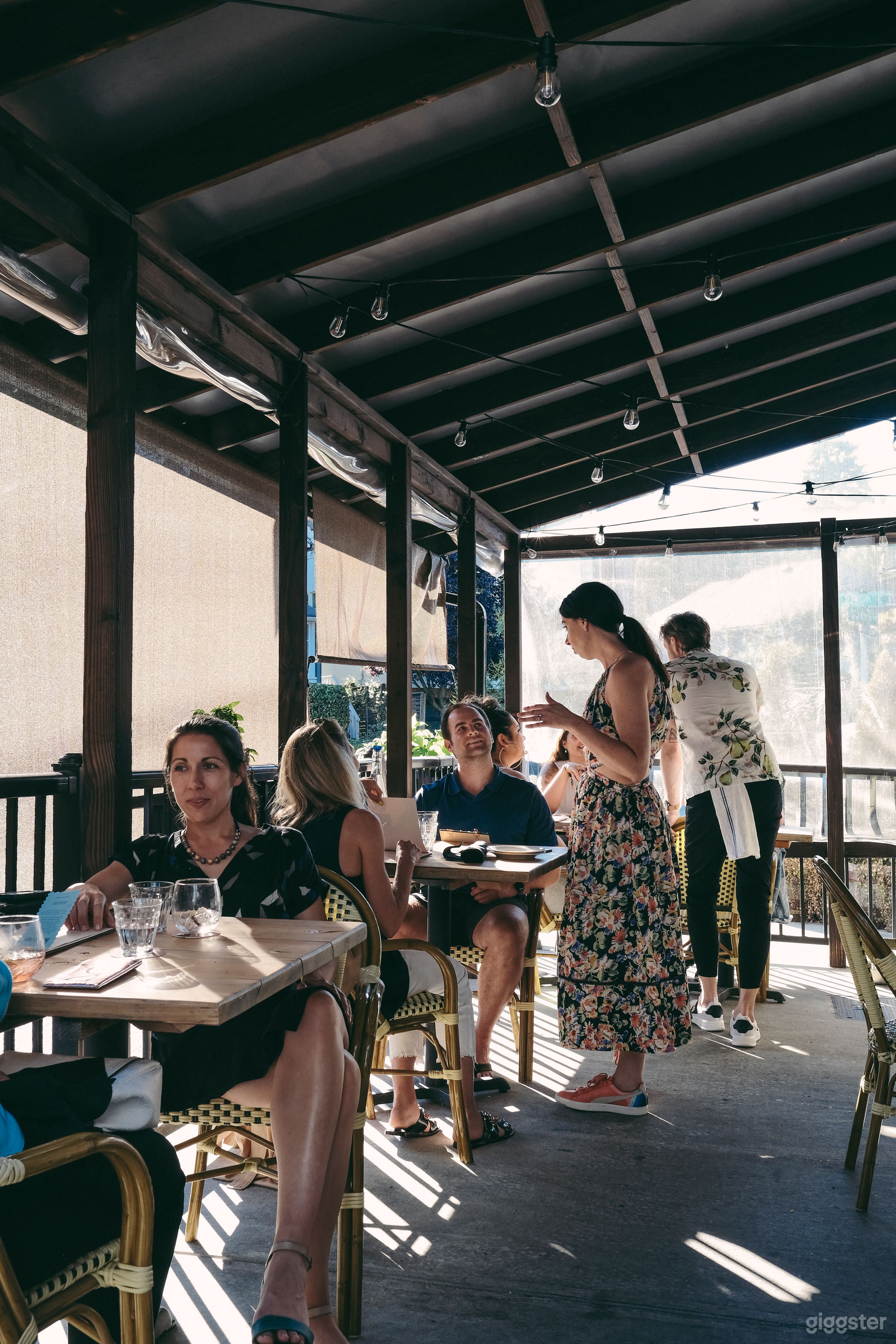 The covered patio is a traditional pergola with greenery along the top barriers (gerrnery not shown in this photo).