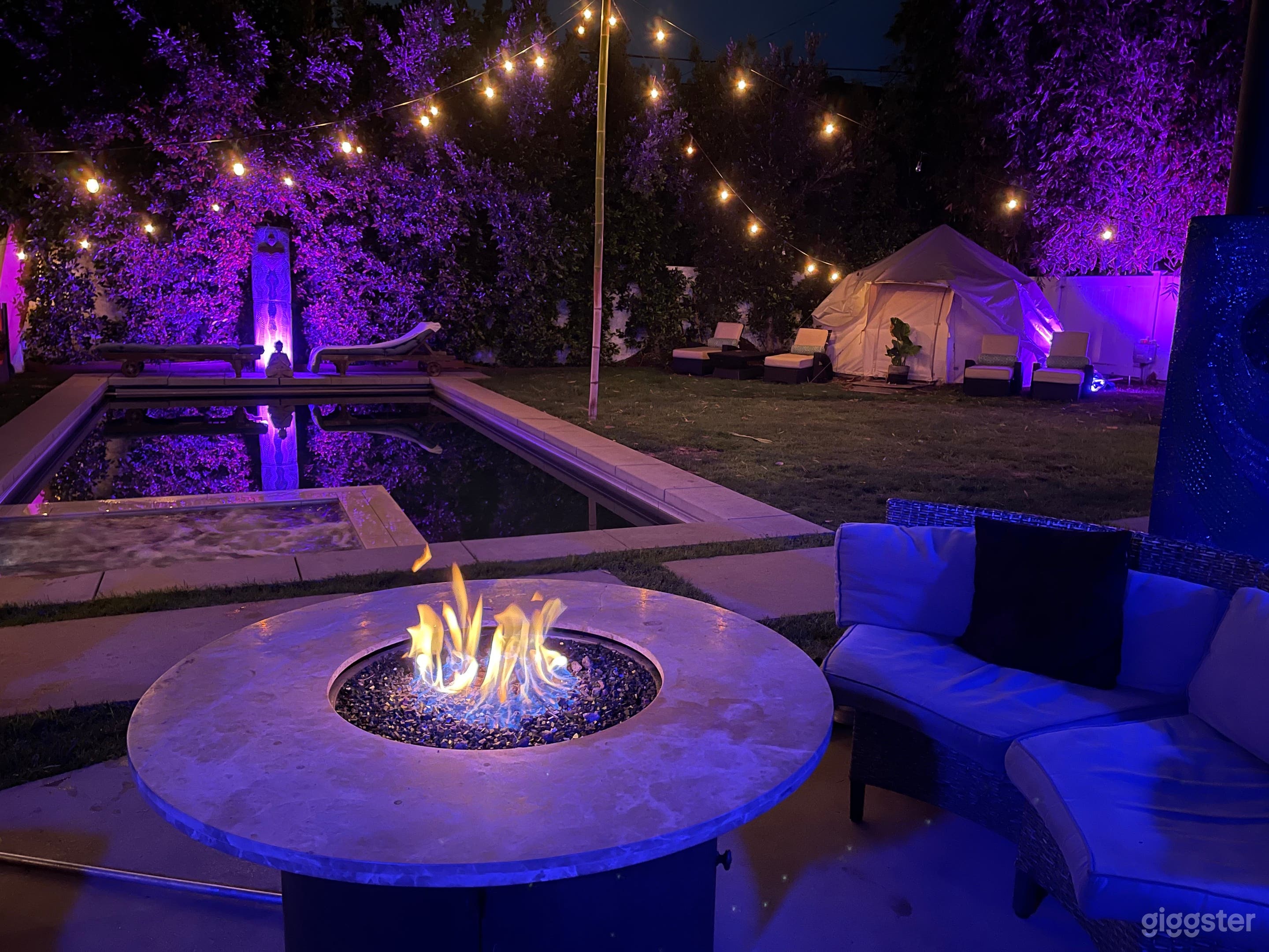 Backyard with hot tub, pool, and patio with fire pit