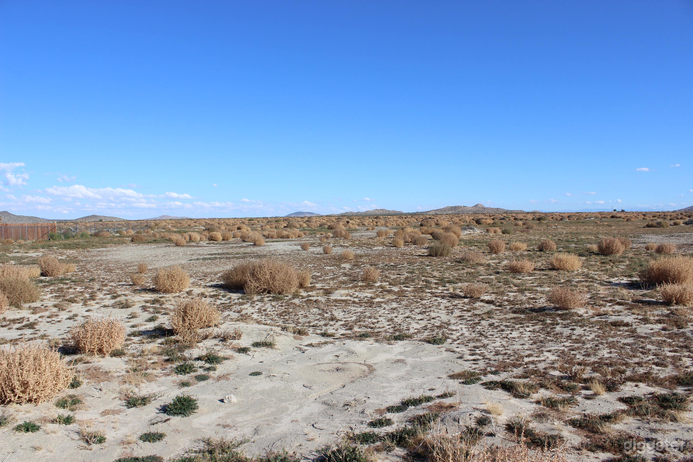 Undeveloped flat open land with distant mountains  Photo 1