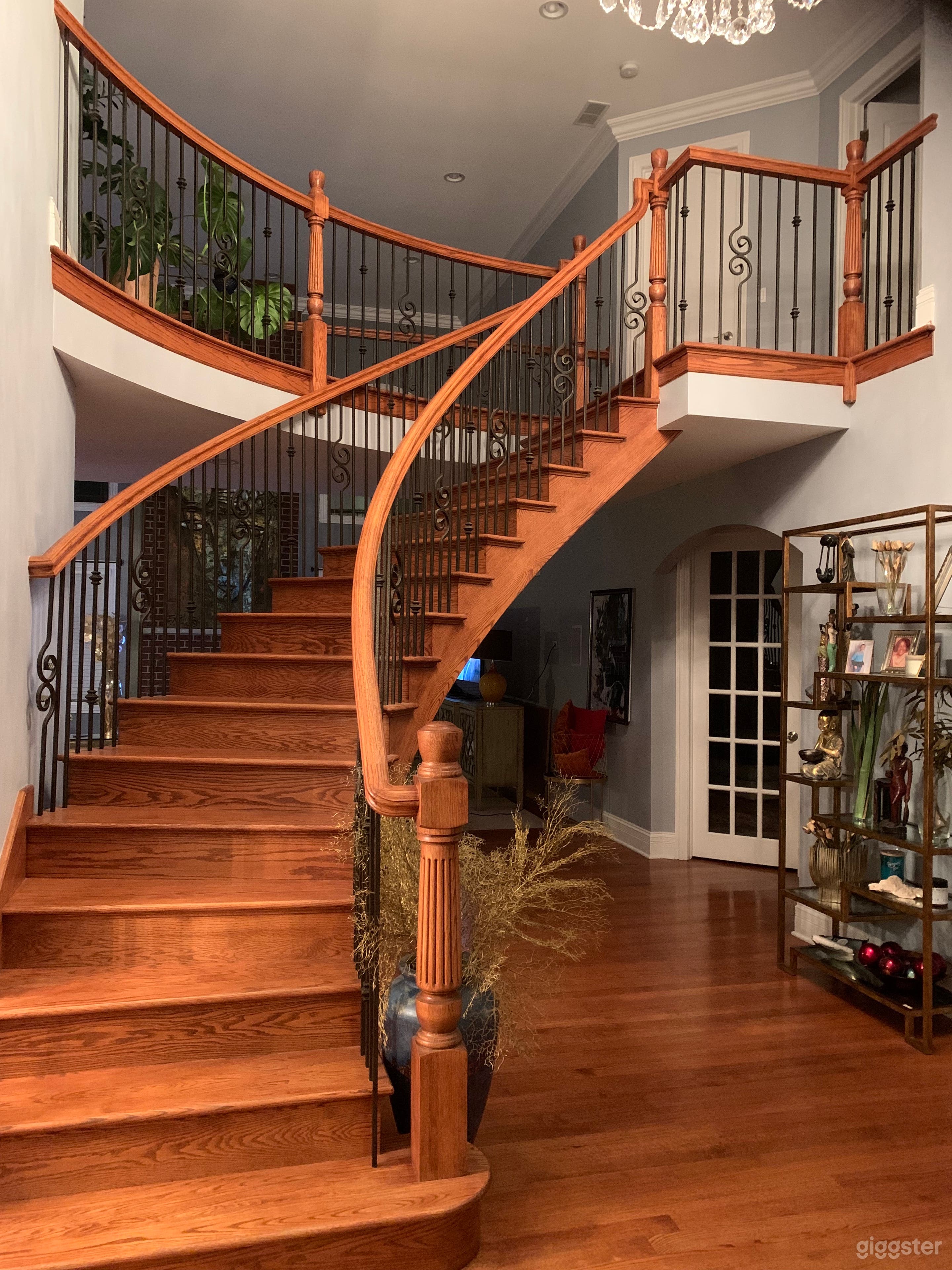 Curved stair case near front door entryway 