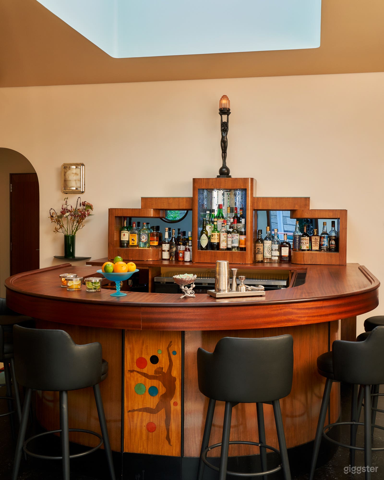 Our beautiful vintage Art Deco horseshoe bar has 10 upholstered stools.