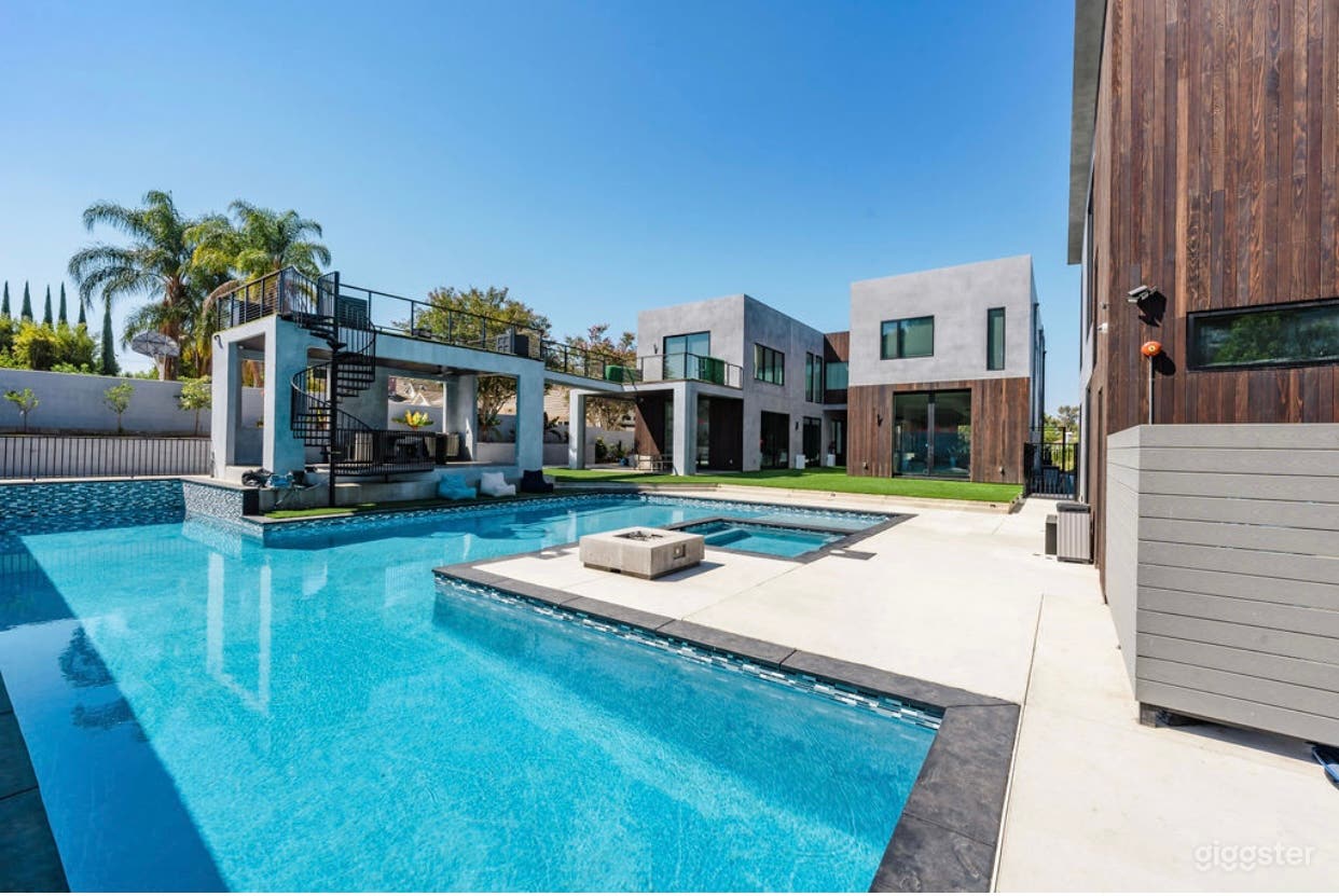 Outdoor pool with attached jacuzzi, wading area, and lap pool. 