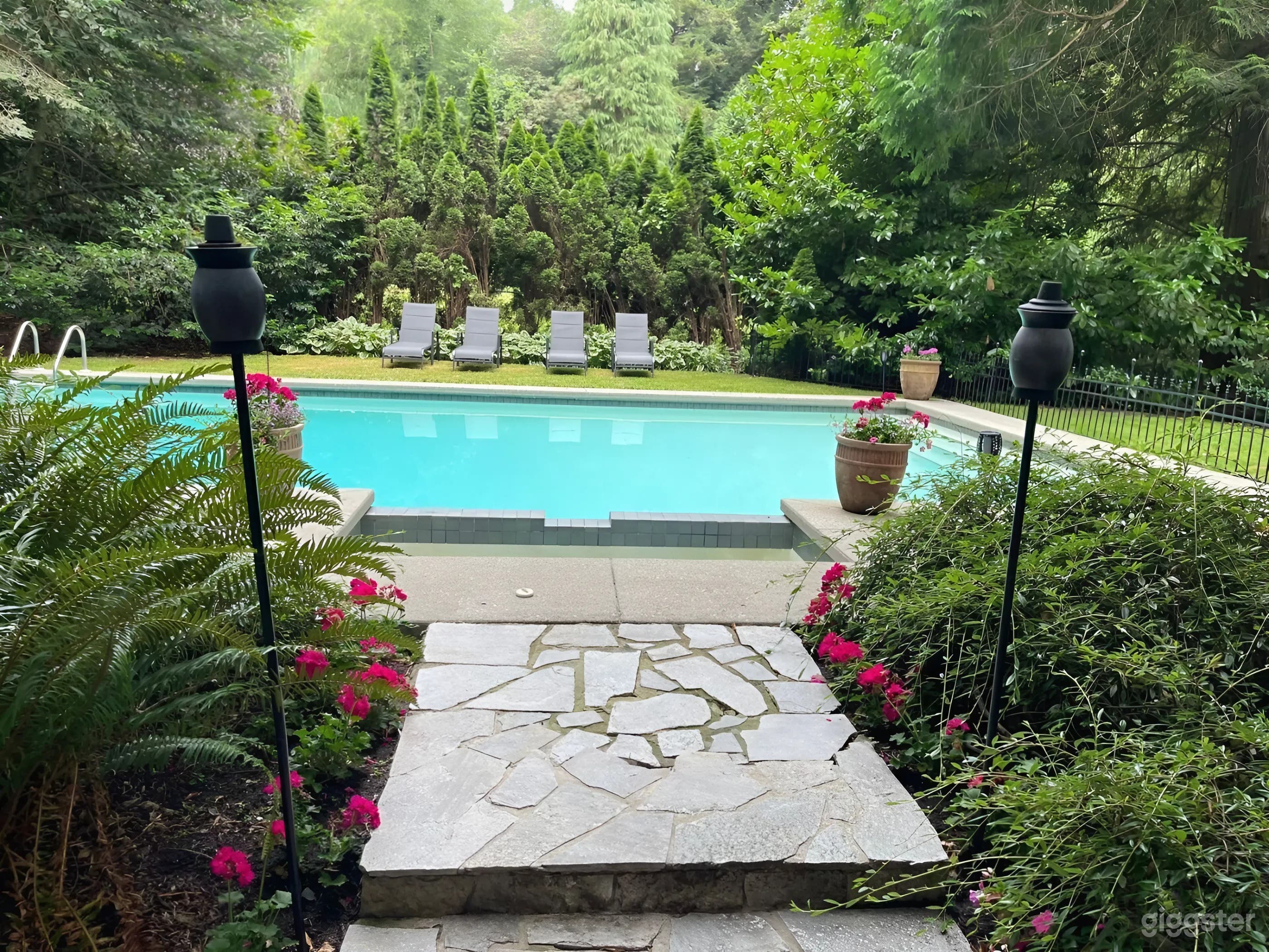 Secluded Oasis with Sparkling Pool Surrounded by Lush Greenery Photo 4