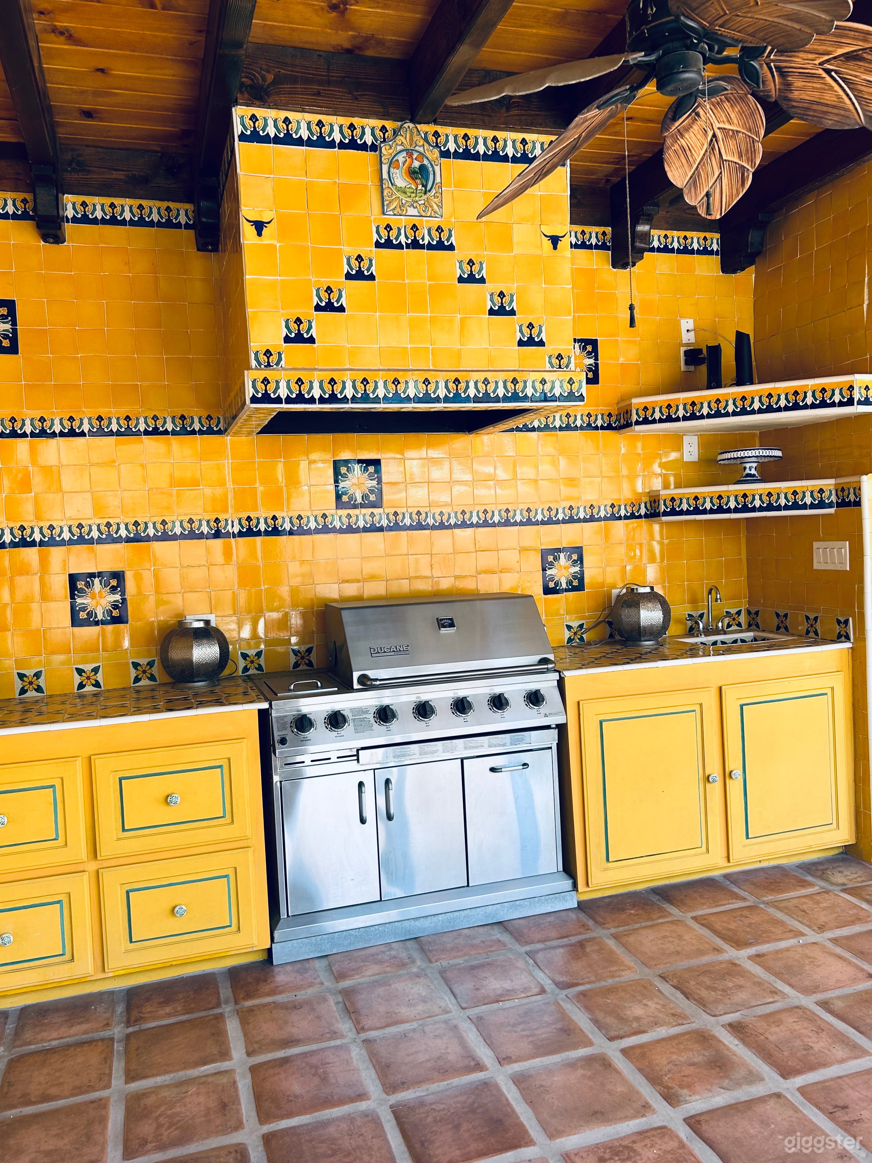 OUTDOOR KITCHEN AREA WITH SINK, BBQ AND CUPBOARDS WITH TONS OF VINTAGE TALAVERA TILES