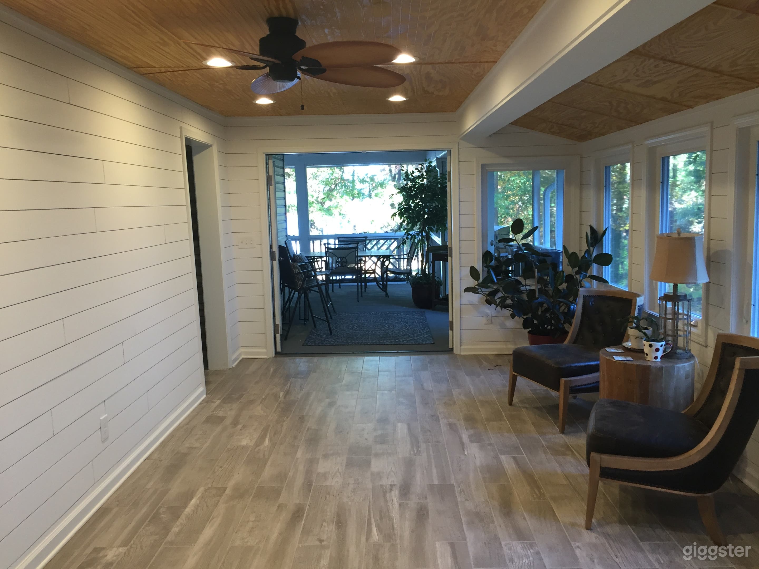  Sunroom with double doors opening to the wraparound screened porch with Lakeview. 