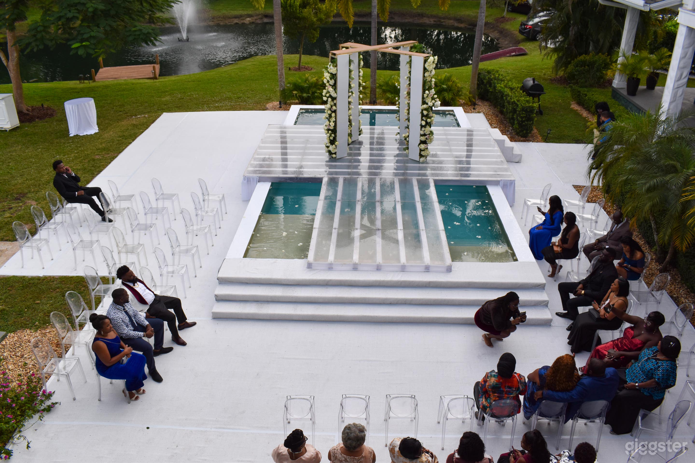 Modern Floating Wedding Aisle Over Pool with Floral Arch at Saint Patrick Palace