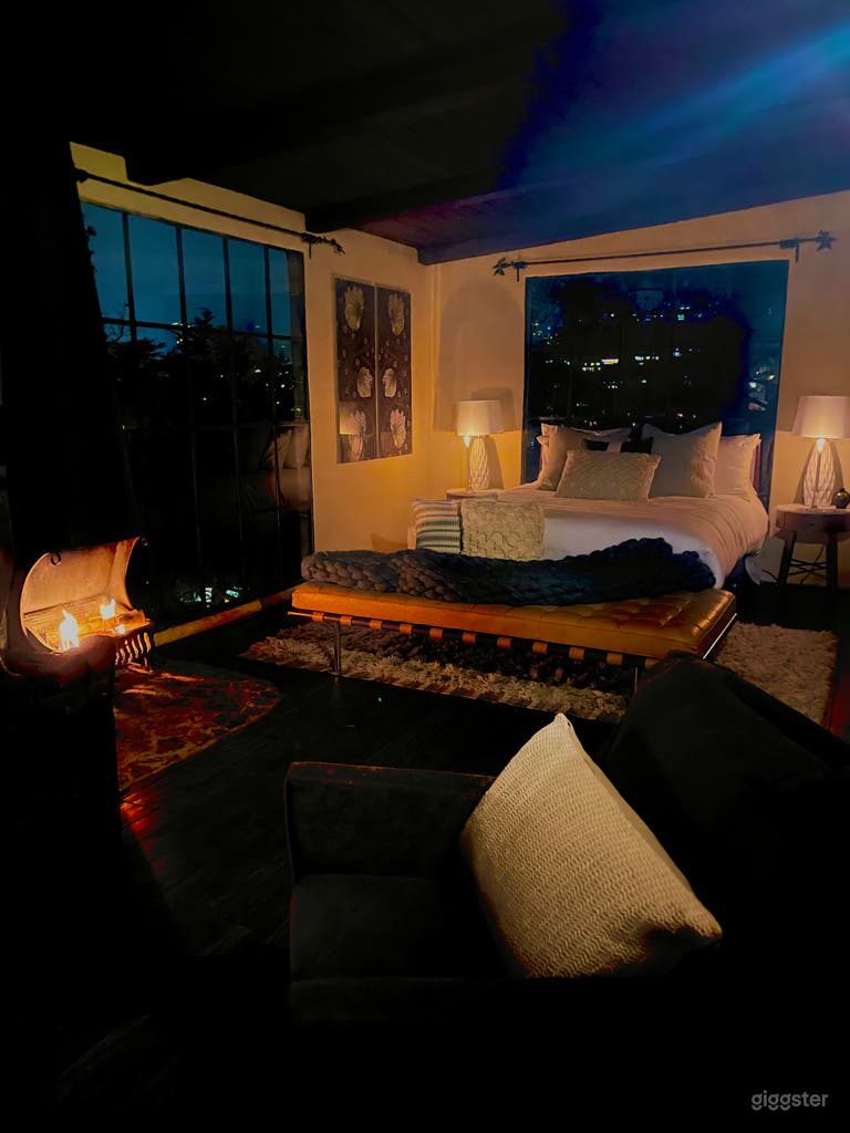  evening upstairs bedroom with fireplace and floor to ceiling windows 