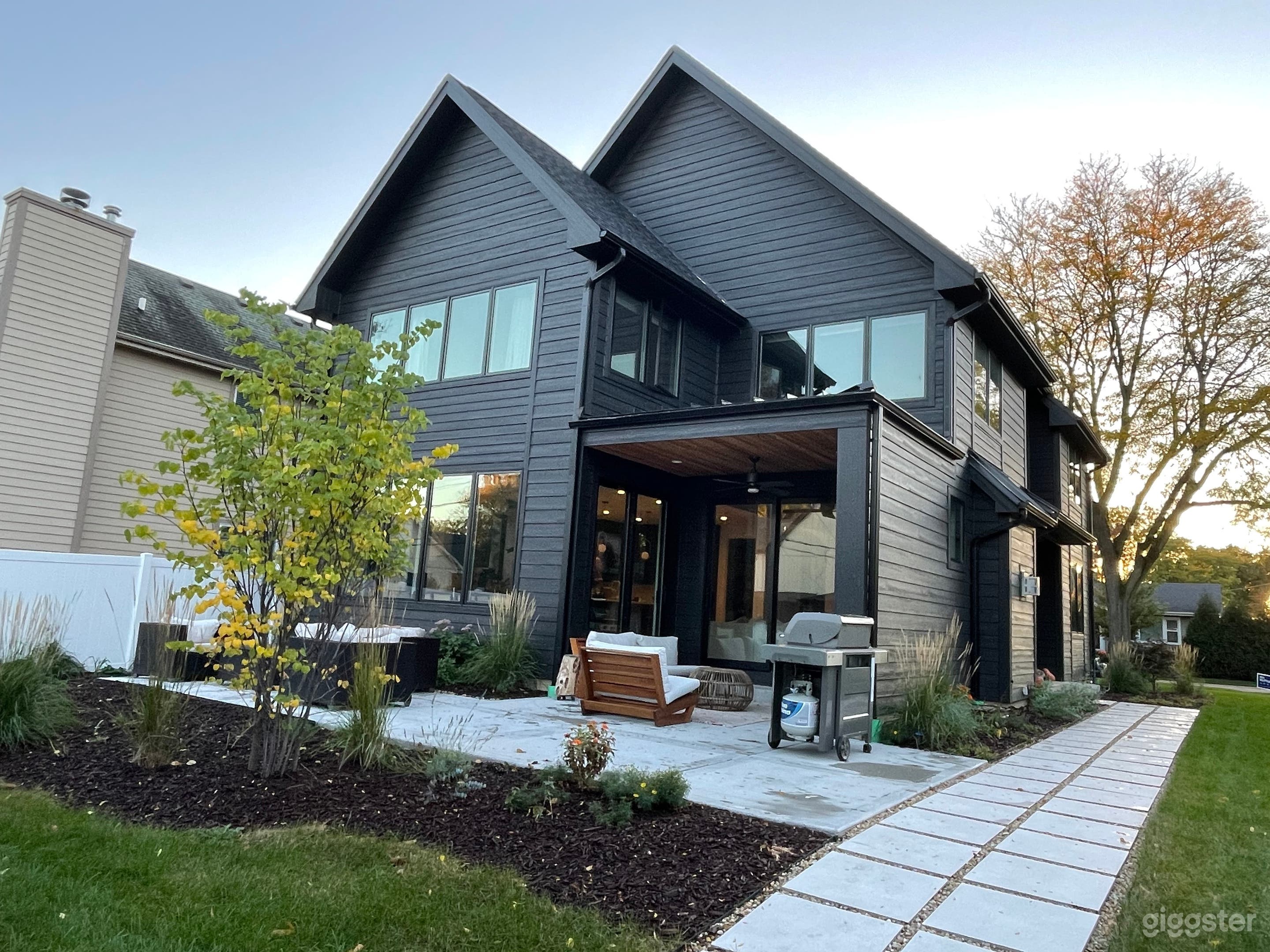 Back of the house with enclosed back porch and paver walkway 