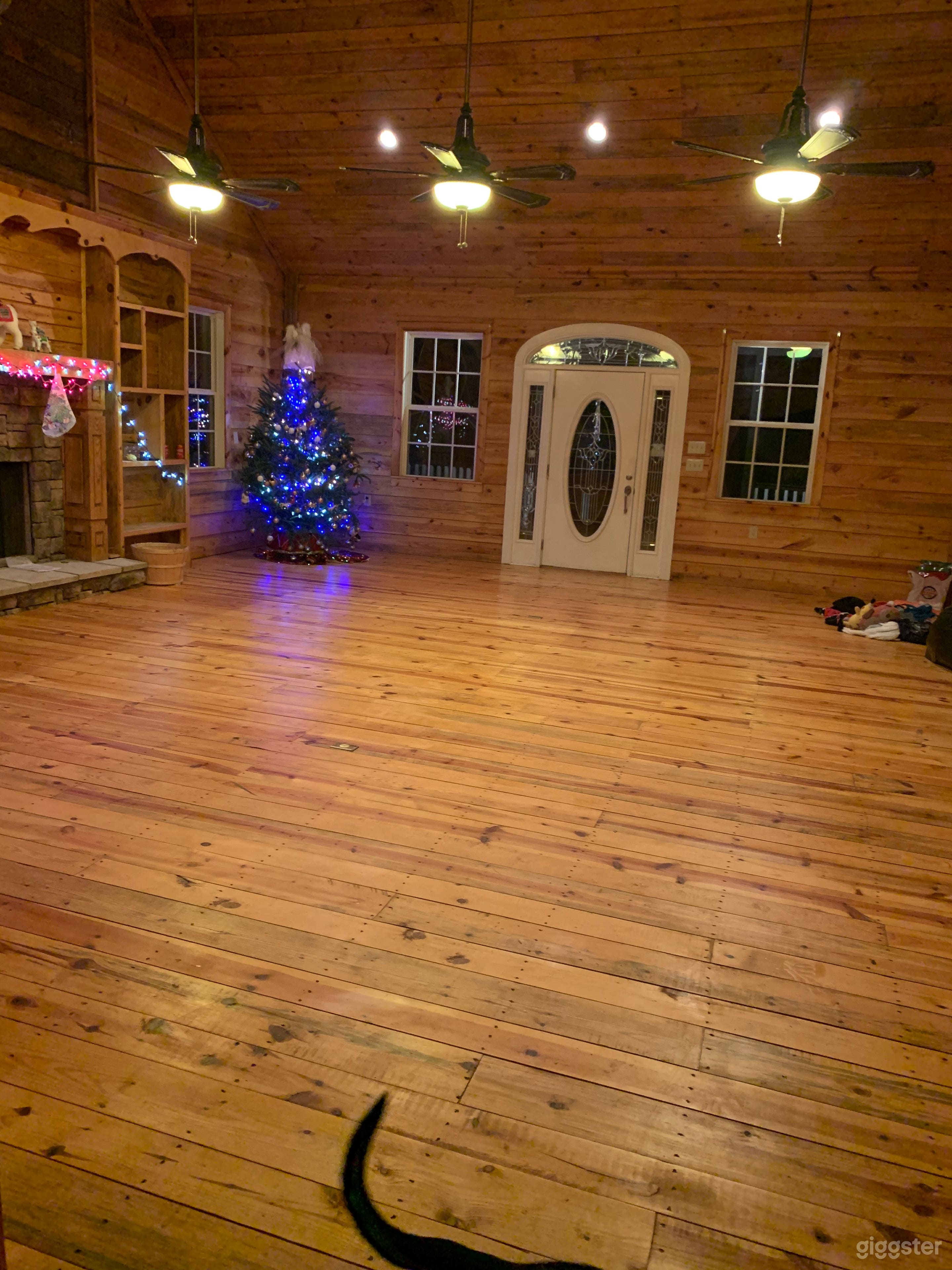 Living room with stone fireplace and mantle.