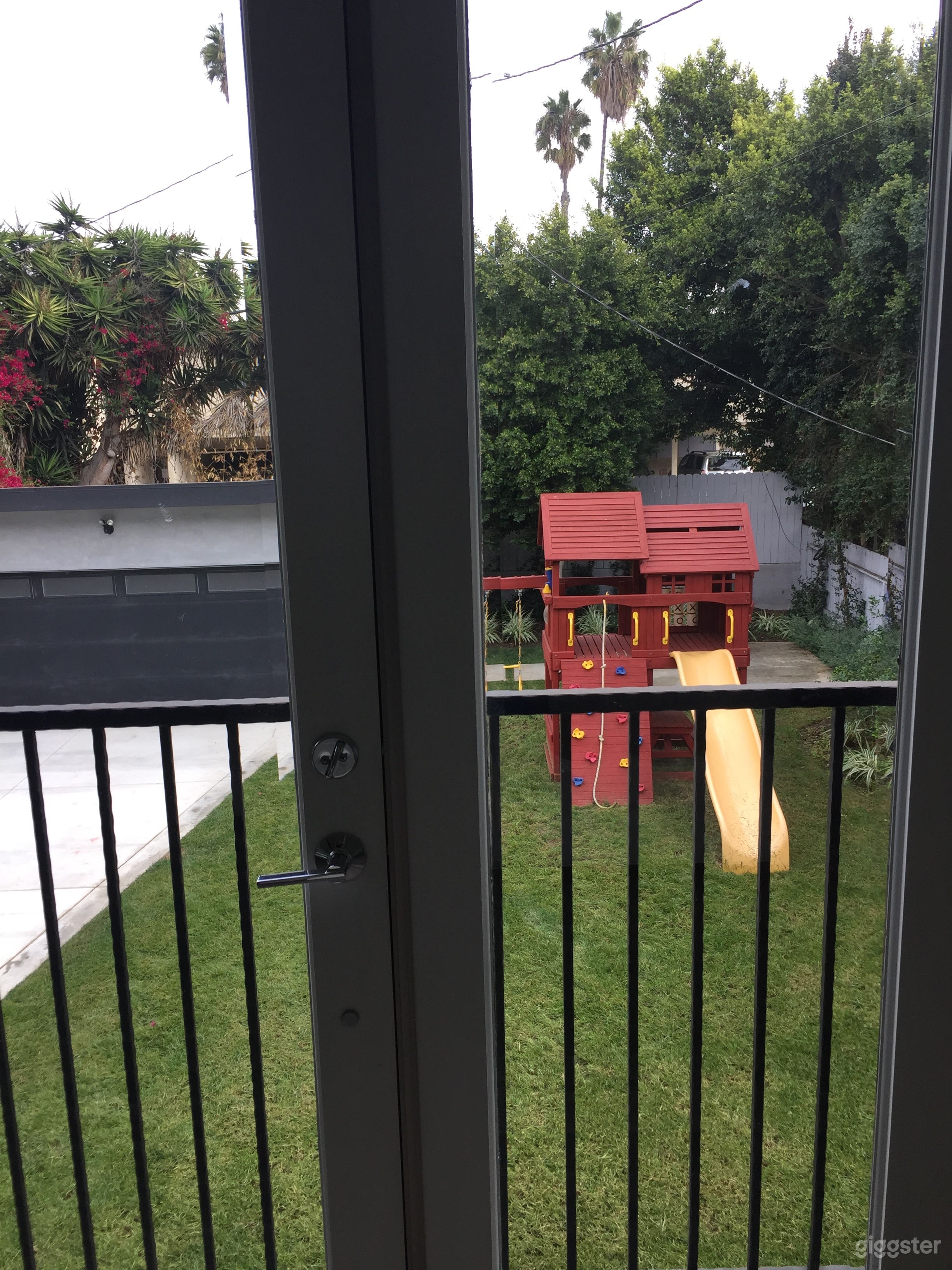 view of backyard garage and yard from master bedroom. Now with trampoline