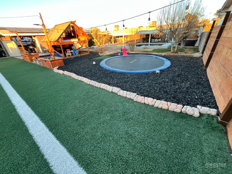  In ground trampoline with front of playhouse 