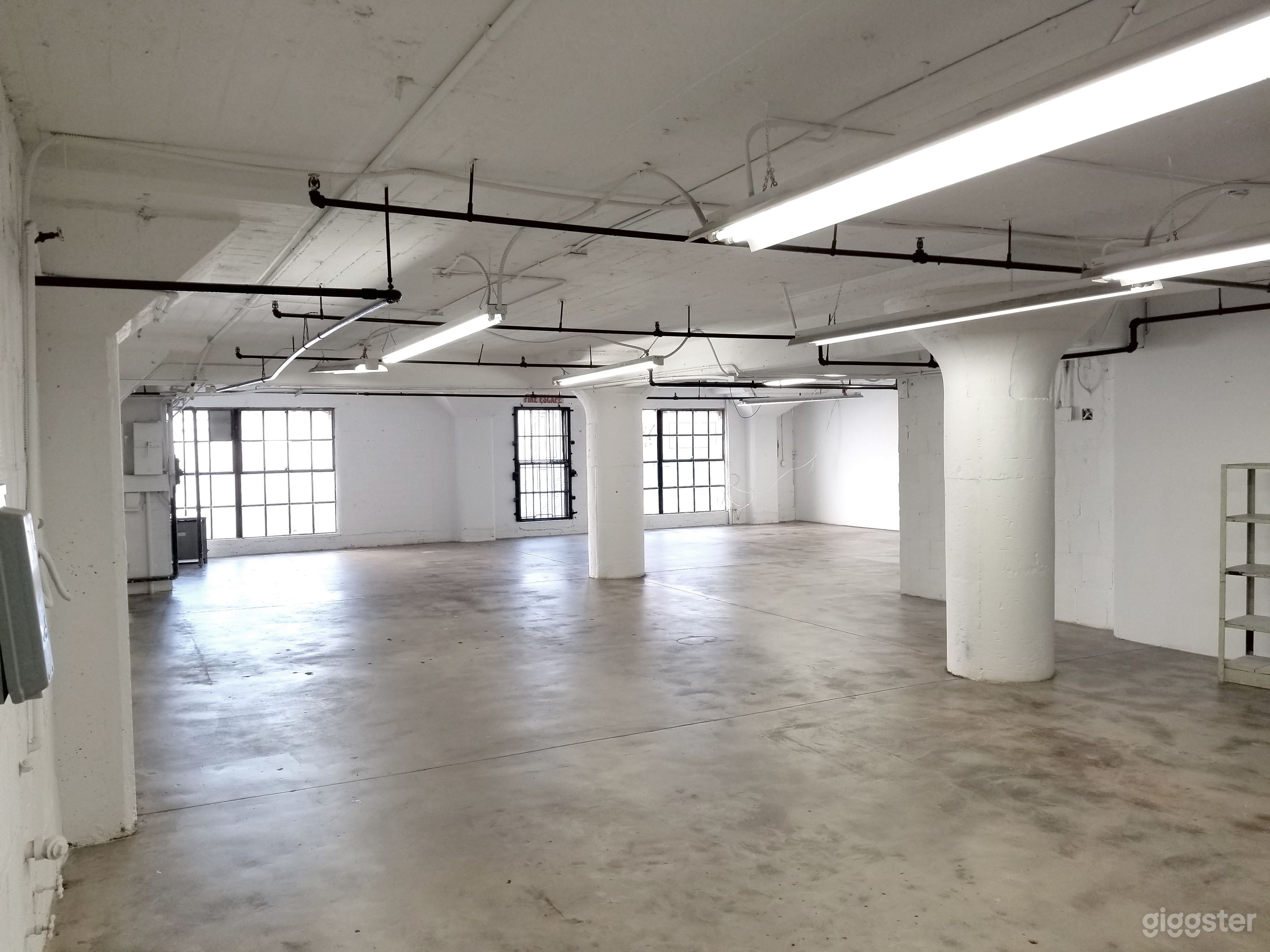 Downtown Studio Loft  Concrete and White Wall  Photo 1