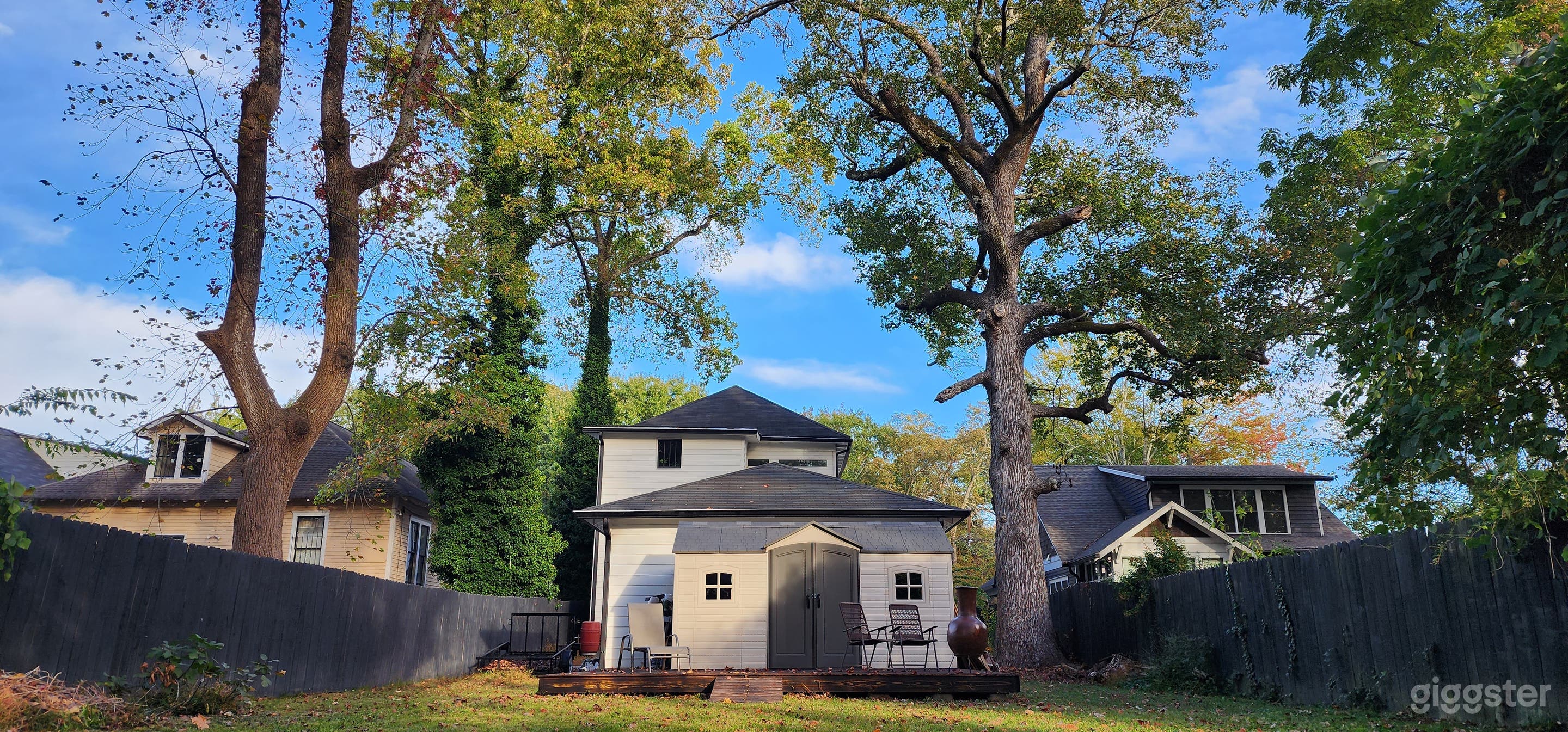 Quiet Green Backyard with Deck and Trees Photo 1