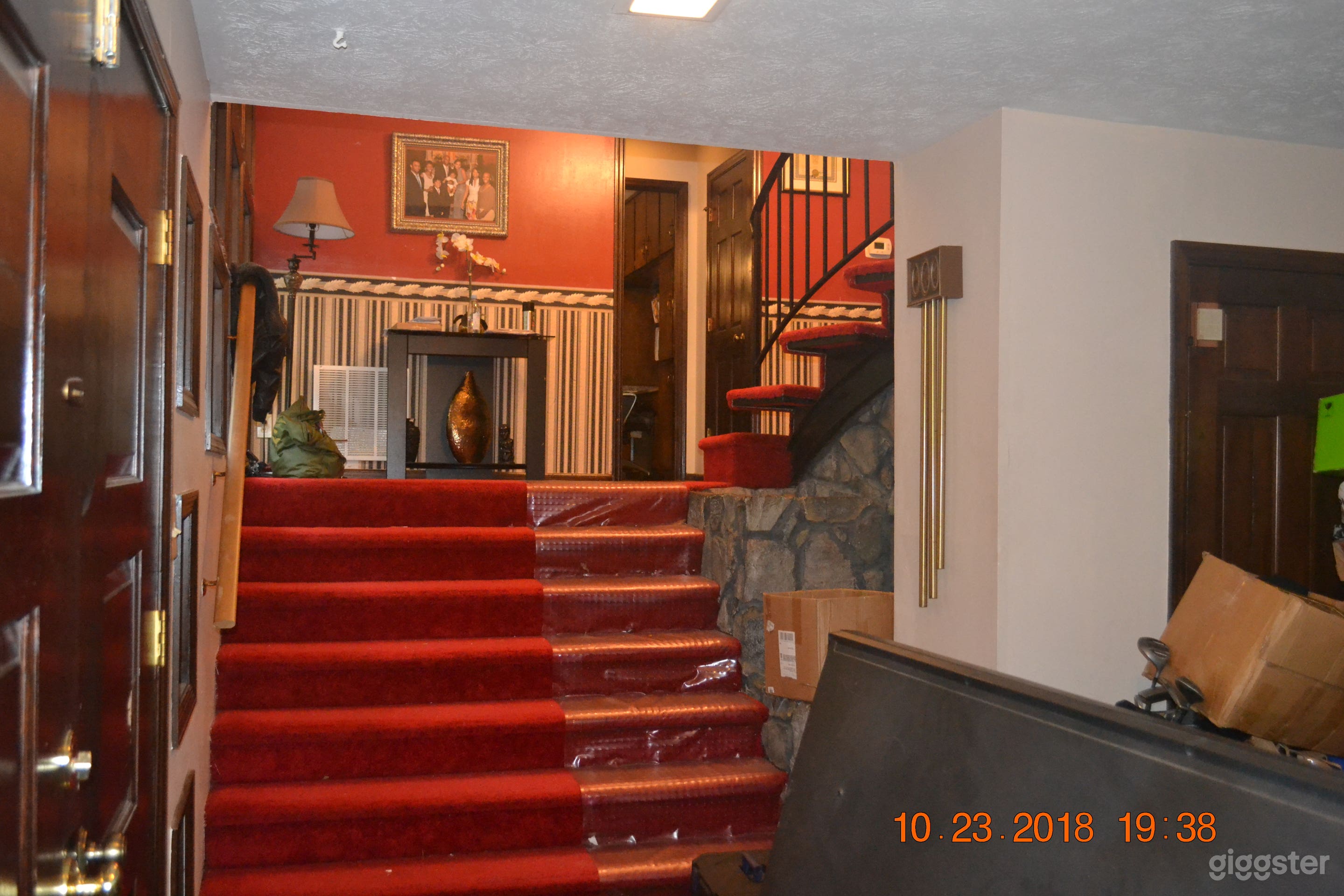 Foyer stairs leading from the fromt door into the main house.