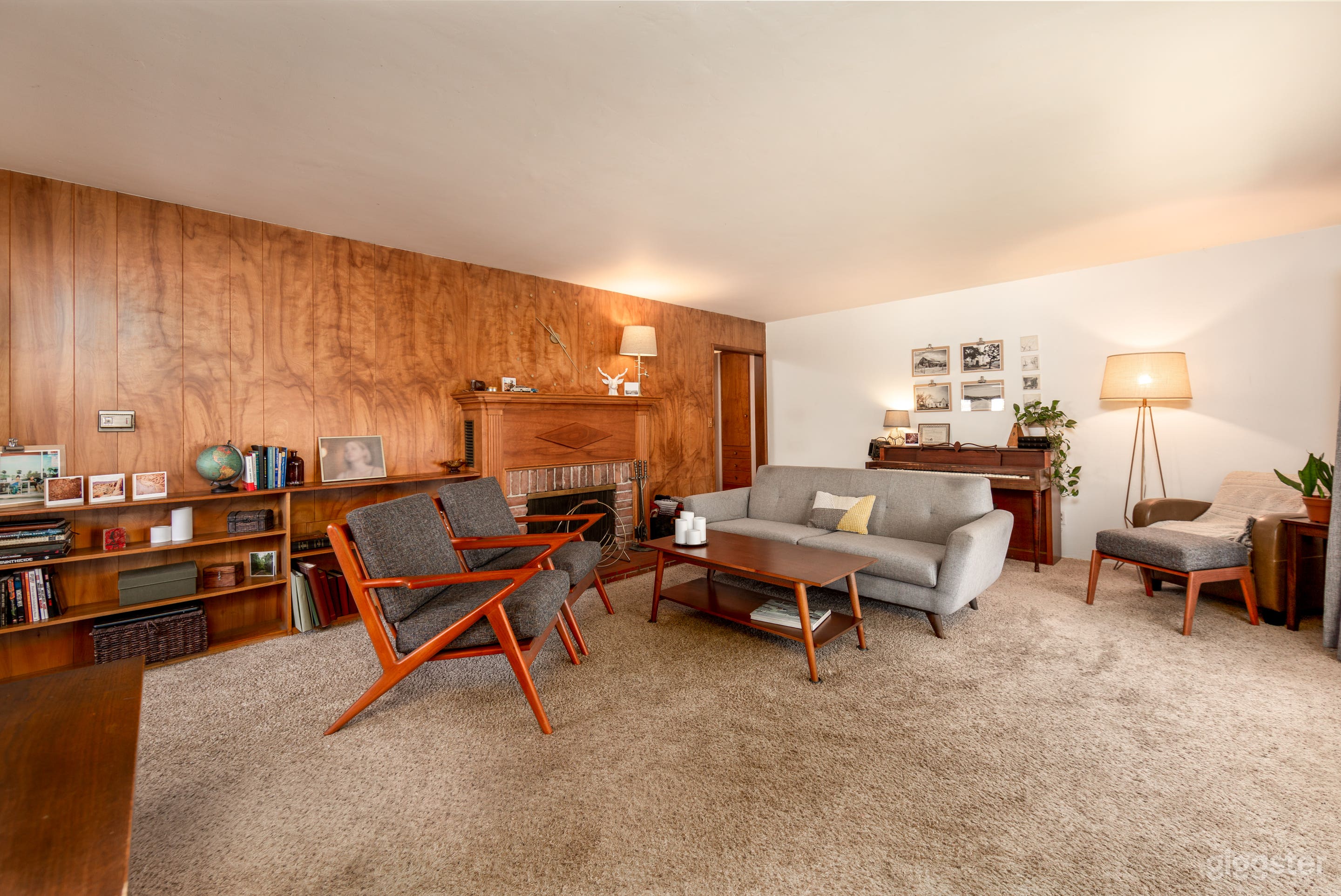 Living room with large wood paneling and mid-century furnishings