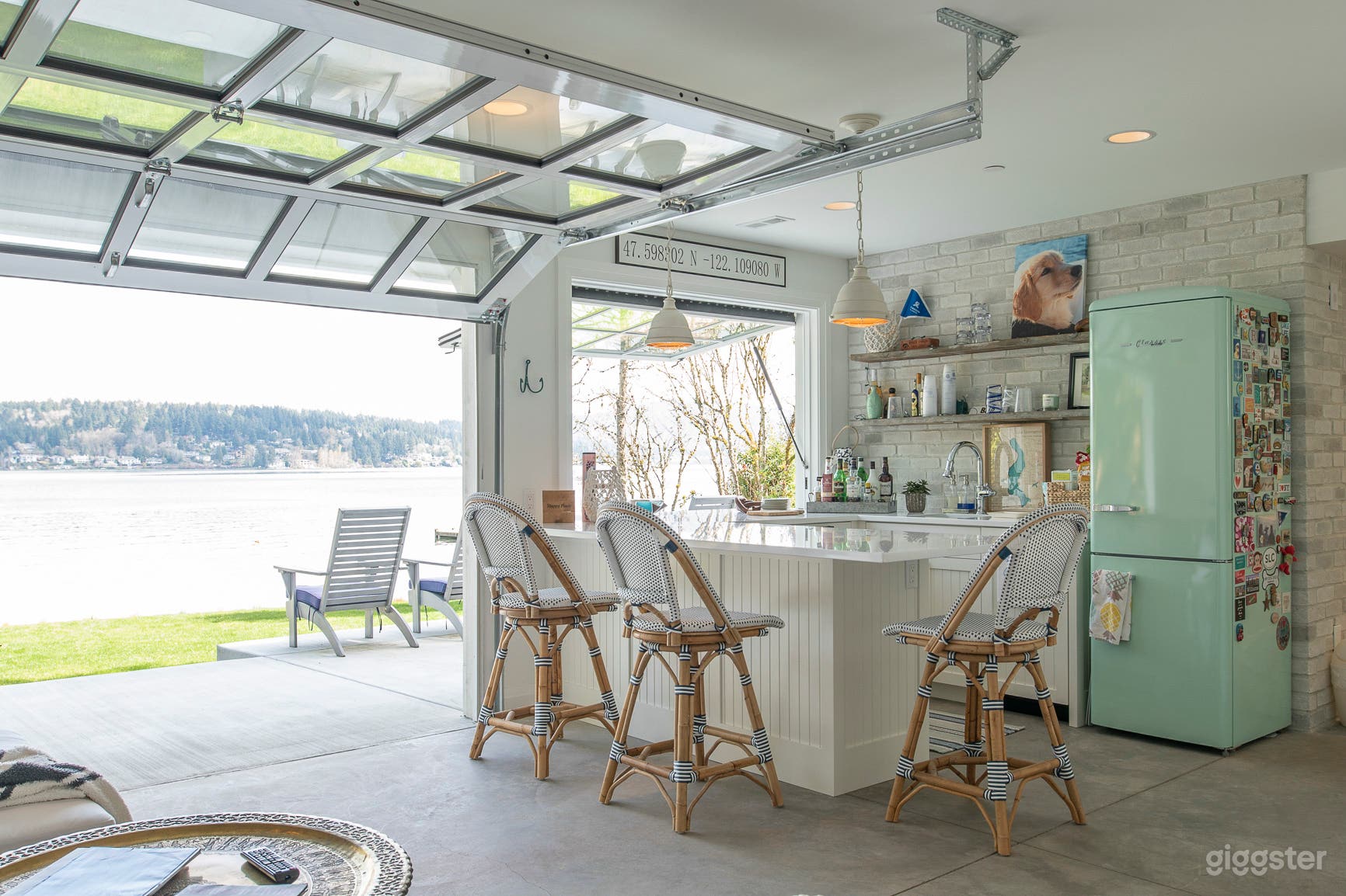 Beach bar with glass garage door, pop out bar window with outdoor bar counter and concrete floors
