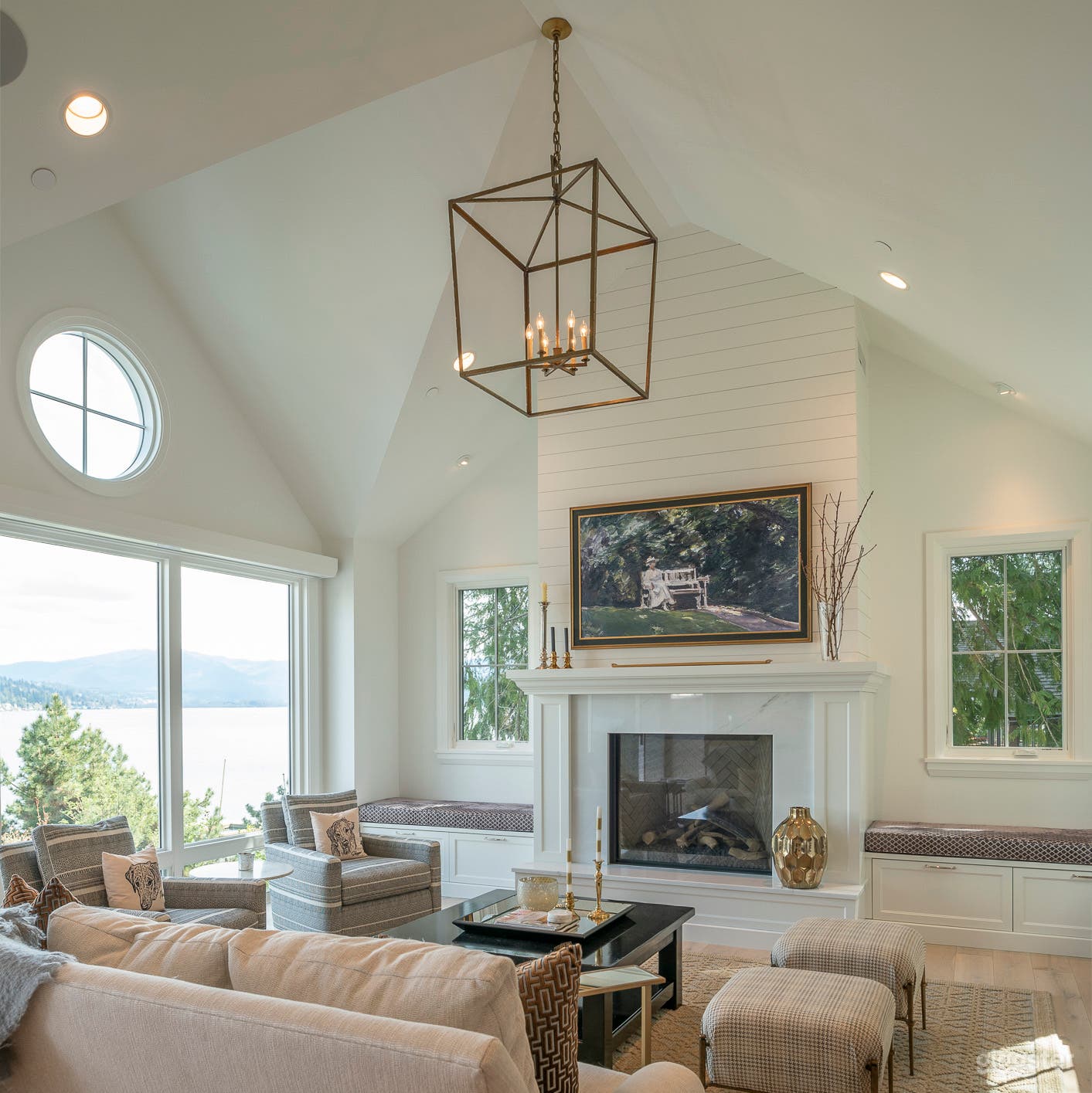 Vaulted ceiling with wall of windows plus gas fireplace with mantle, marble surround and seat, flanked by cushioned window seats