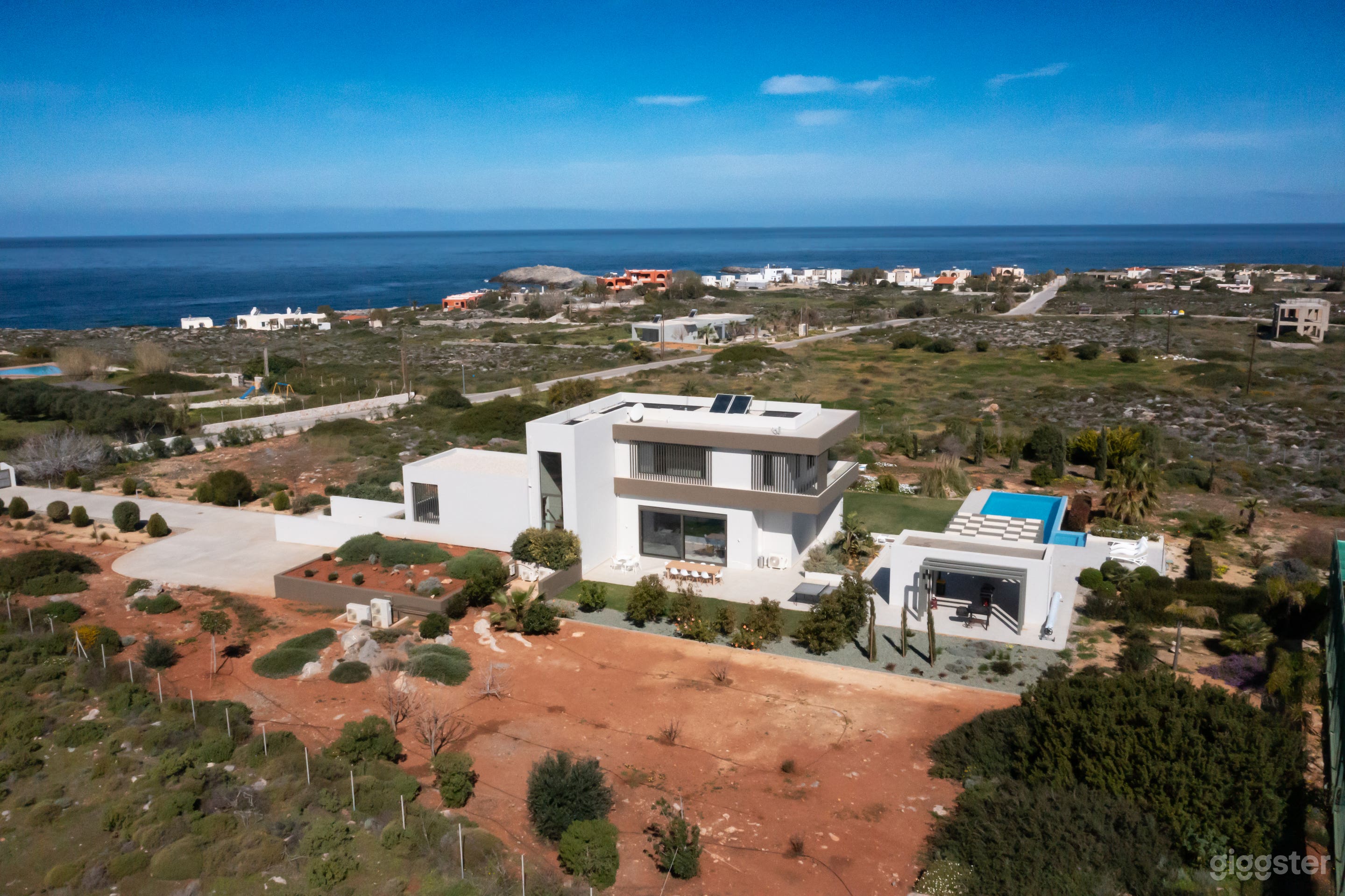Exterior with infinity pool and private tennis court