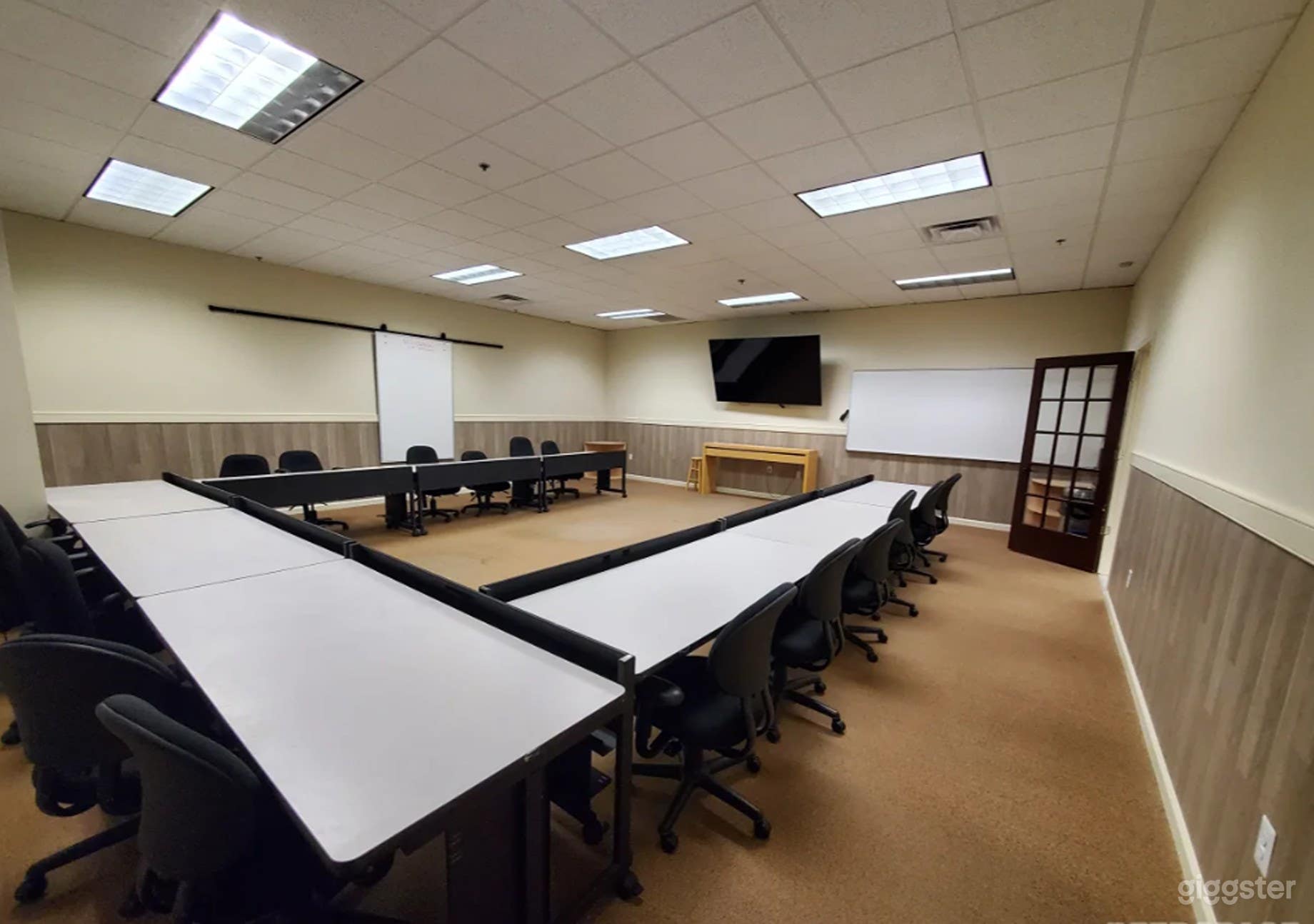 Spacious Meeting Room with Large TV and Whiteboard Photo 1