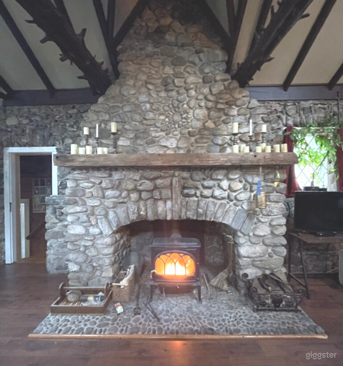 Floor-to-ceiling original fireplace, with working wood stove.