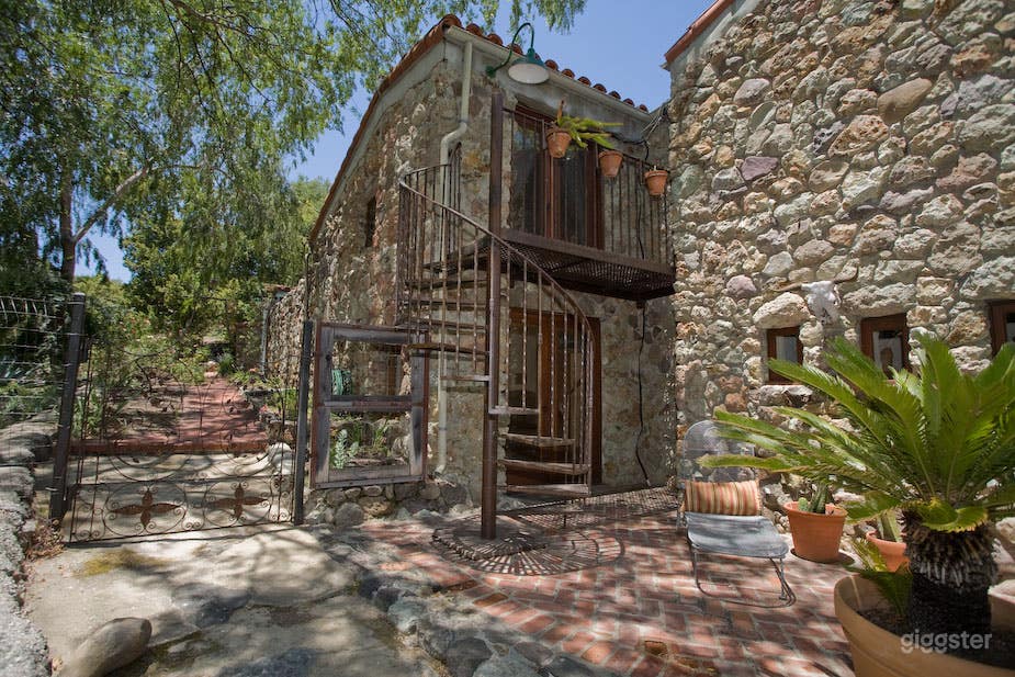 balcony and circular stairway from house