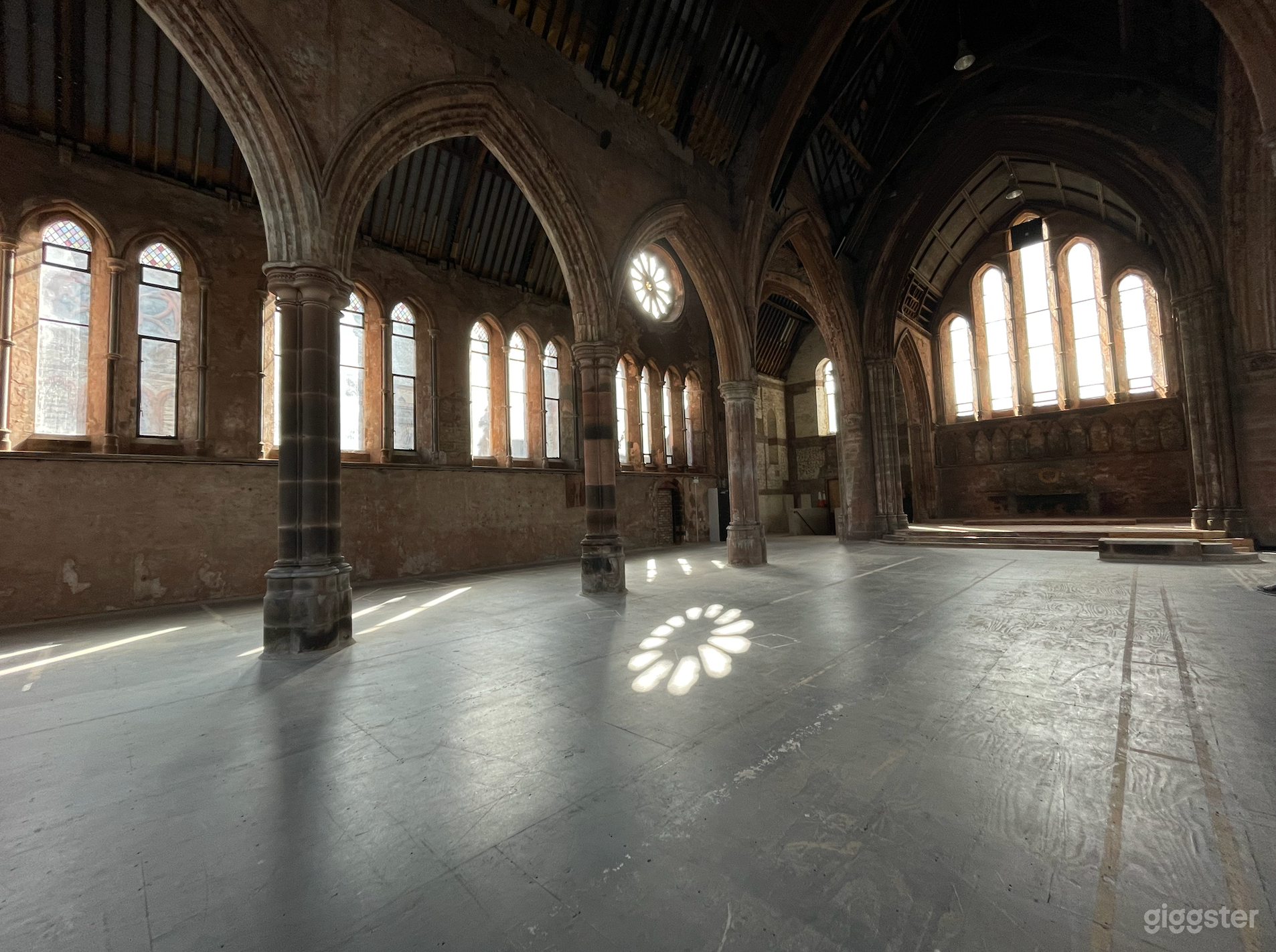 The building’s interior space is essentially a single, double-height space, including a central nave and arched side aisles.