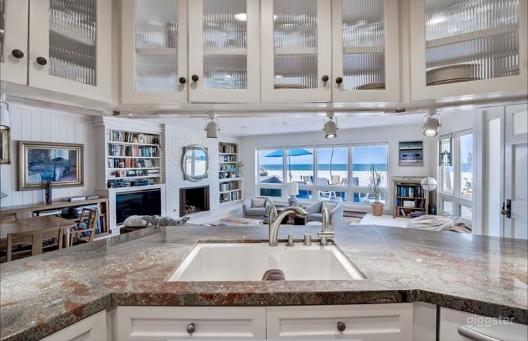  Kitchen facing the living area with a beach and ocean view 