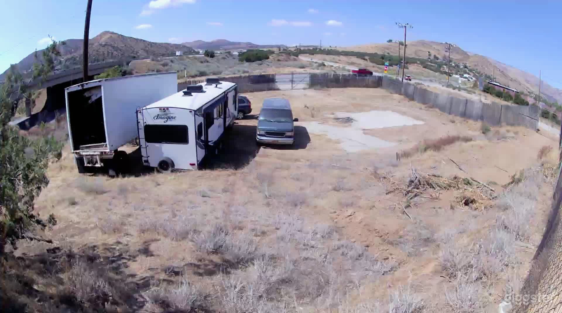 View from our upper property looking west  with desert views of a commercial lot.  We have stored vehicles on a commercial lot that is fenced and gated. 
