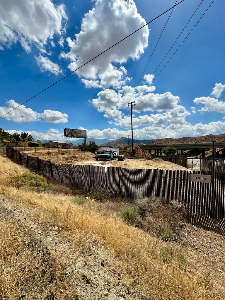  View of lot with desert views of a commercial lot.  We have stored vehicles on a commercial lot that is fenced and gated. You can see the rest of our property to the left/east in the photo. 
