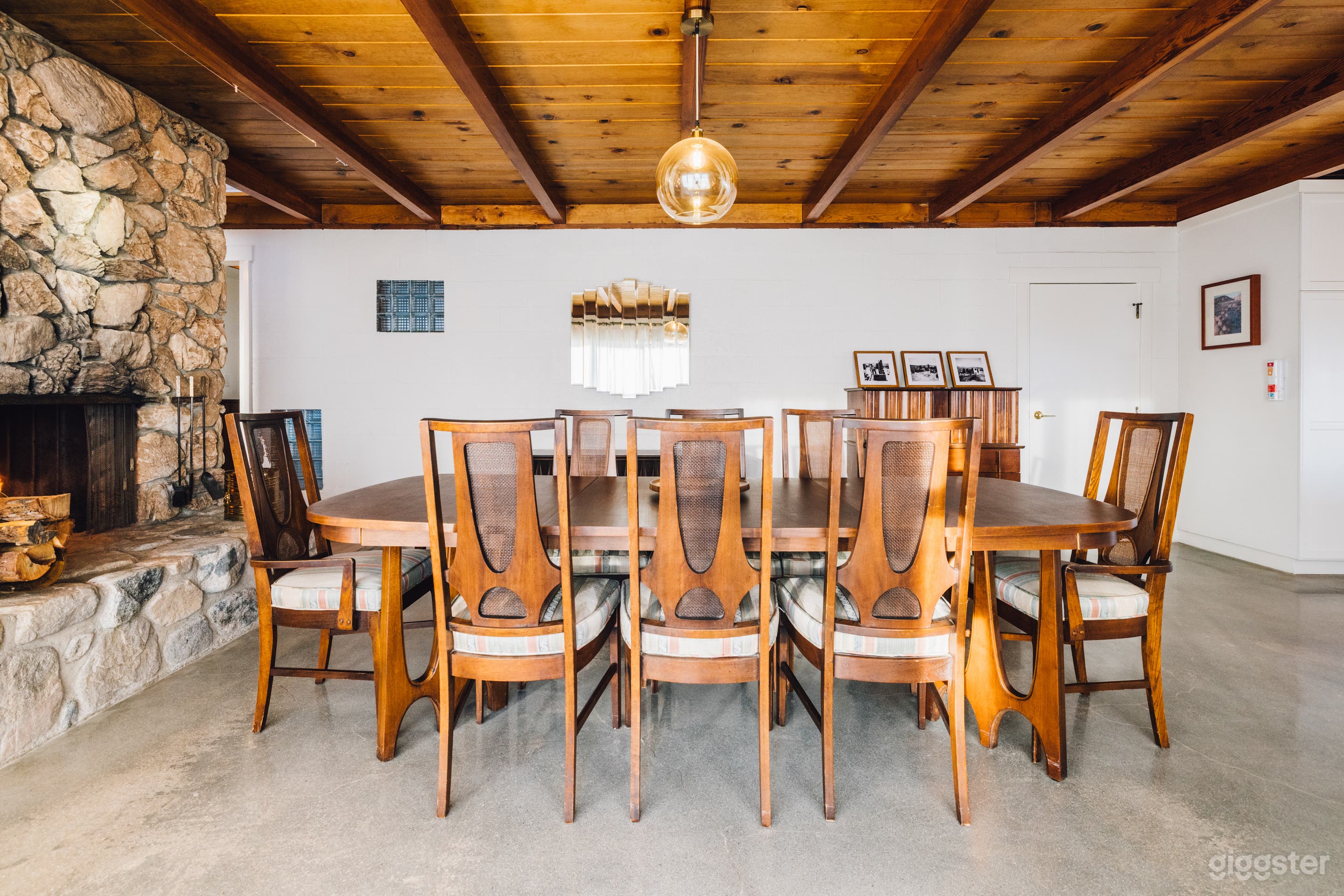 Mid Century Dinning Room with original Mid Century  Brazilian furnishings, large stone faced fireplace and exposed wood beam ceilings