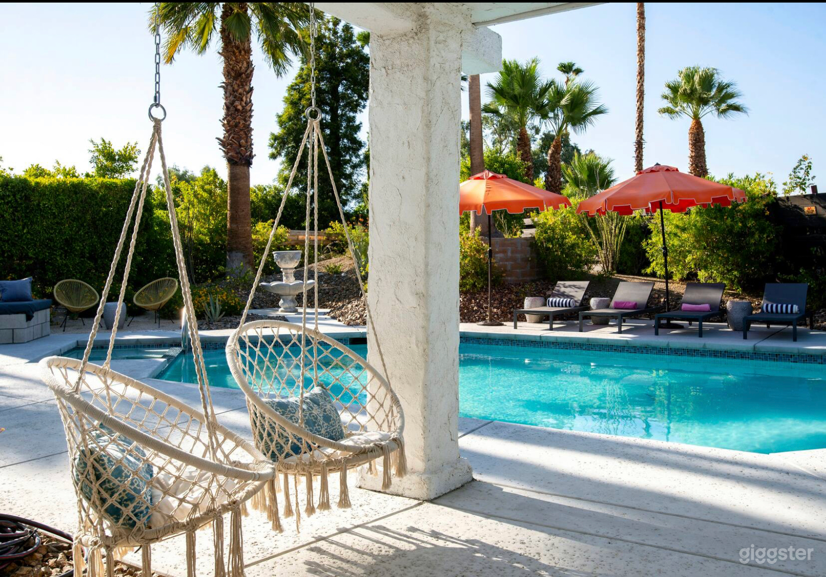 Swinging chairs, outside dining table directly across. Seats six.