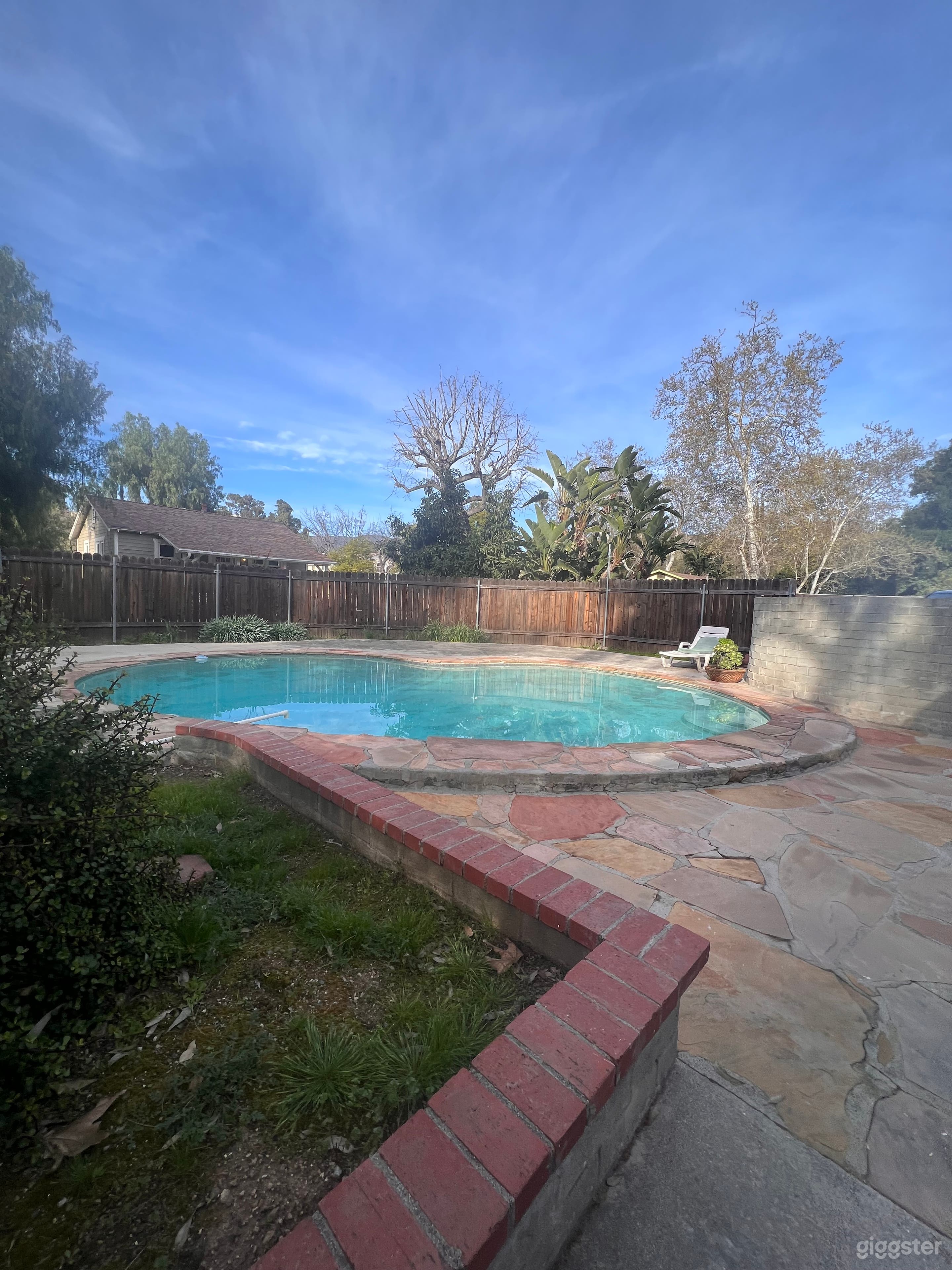 Versatile pool completely fenced in the middle of two houses can be fancier or more laid back depending possibly built in the 70s