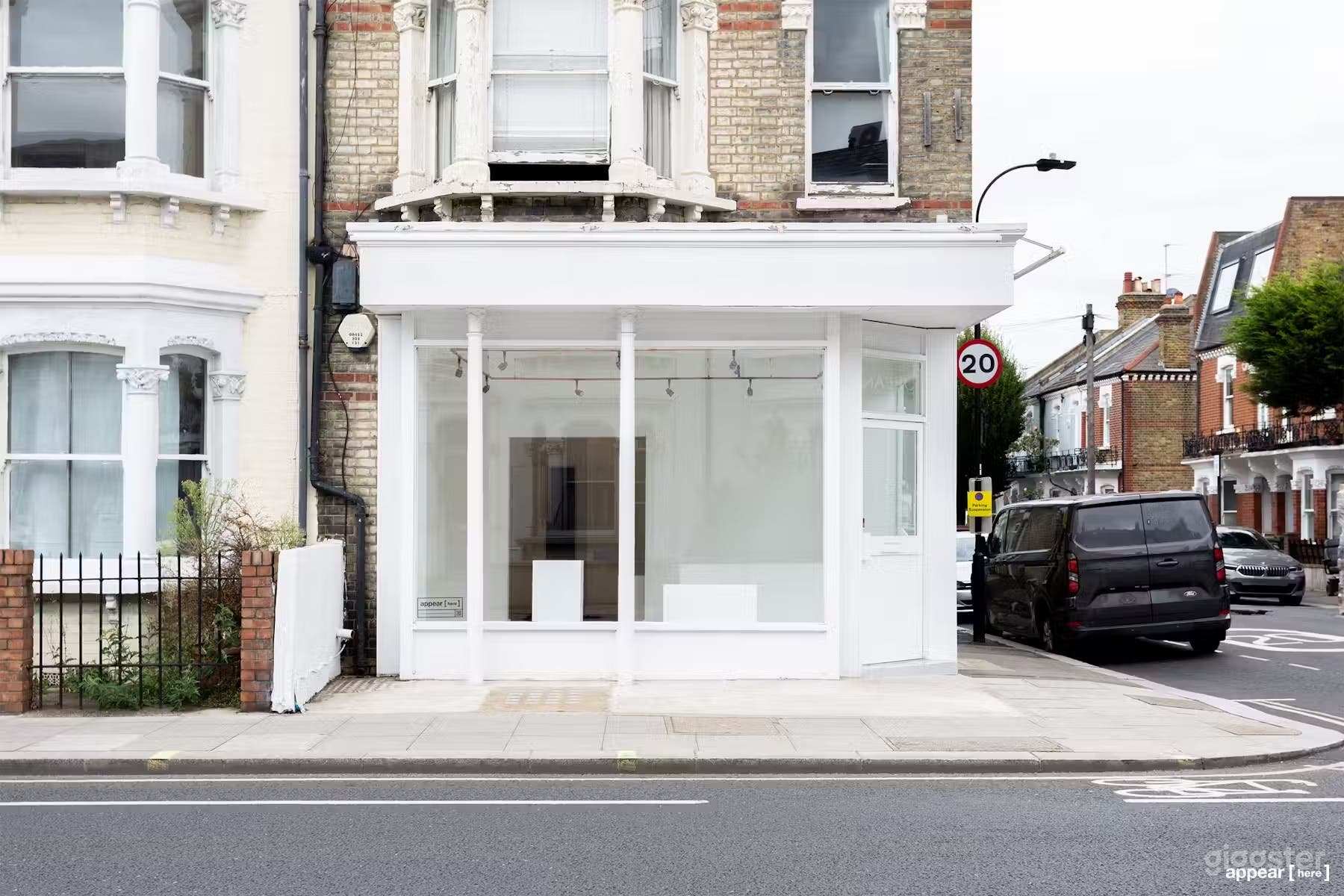 The lovely corner gallery shop front featuring two large shopfront windows allowing daylight to filter in.