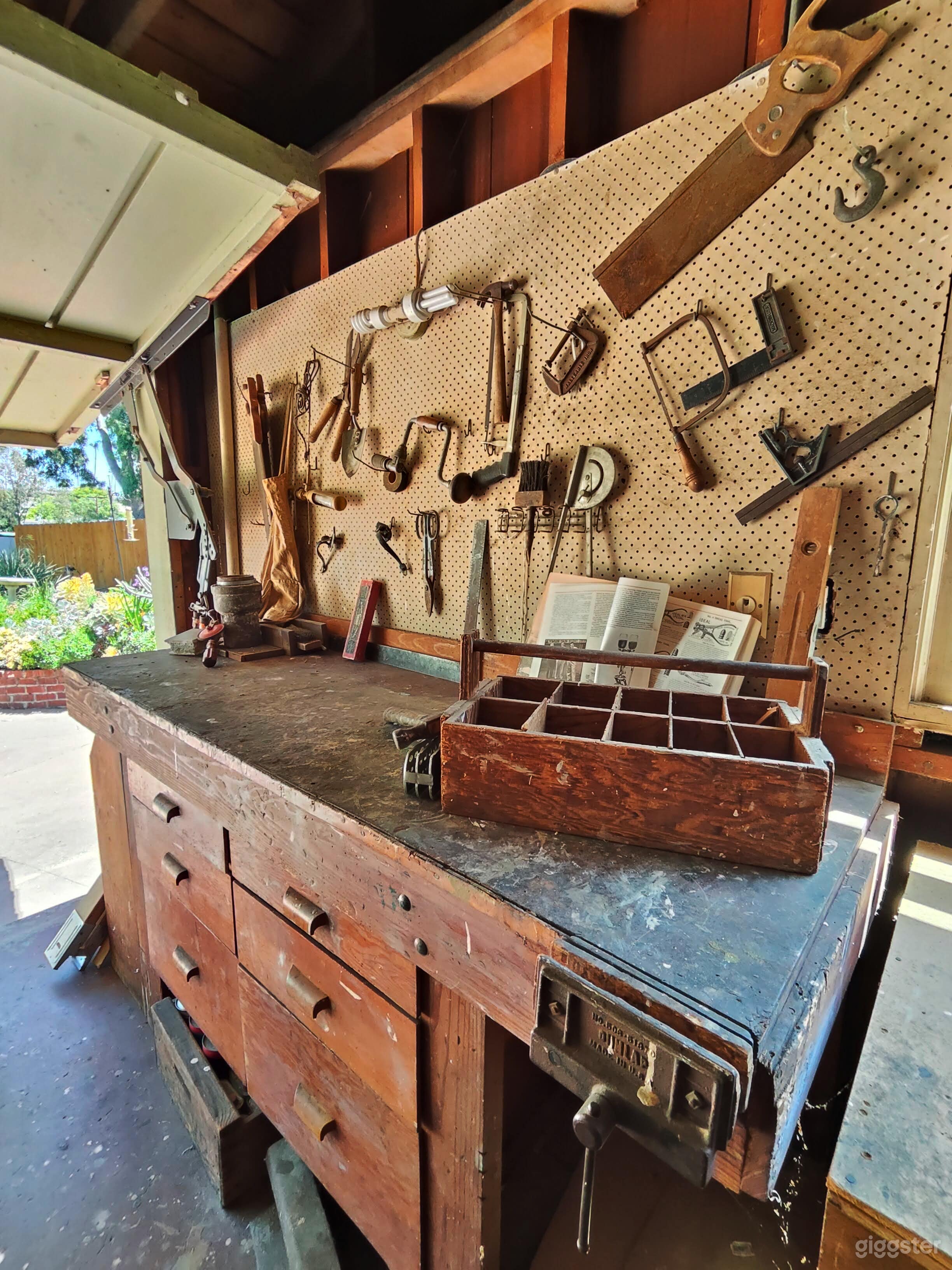 Workshop with original tools, with tilt garage door to large open patio space with gorgeous natural light.