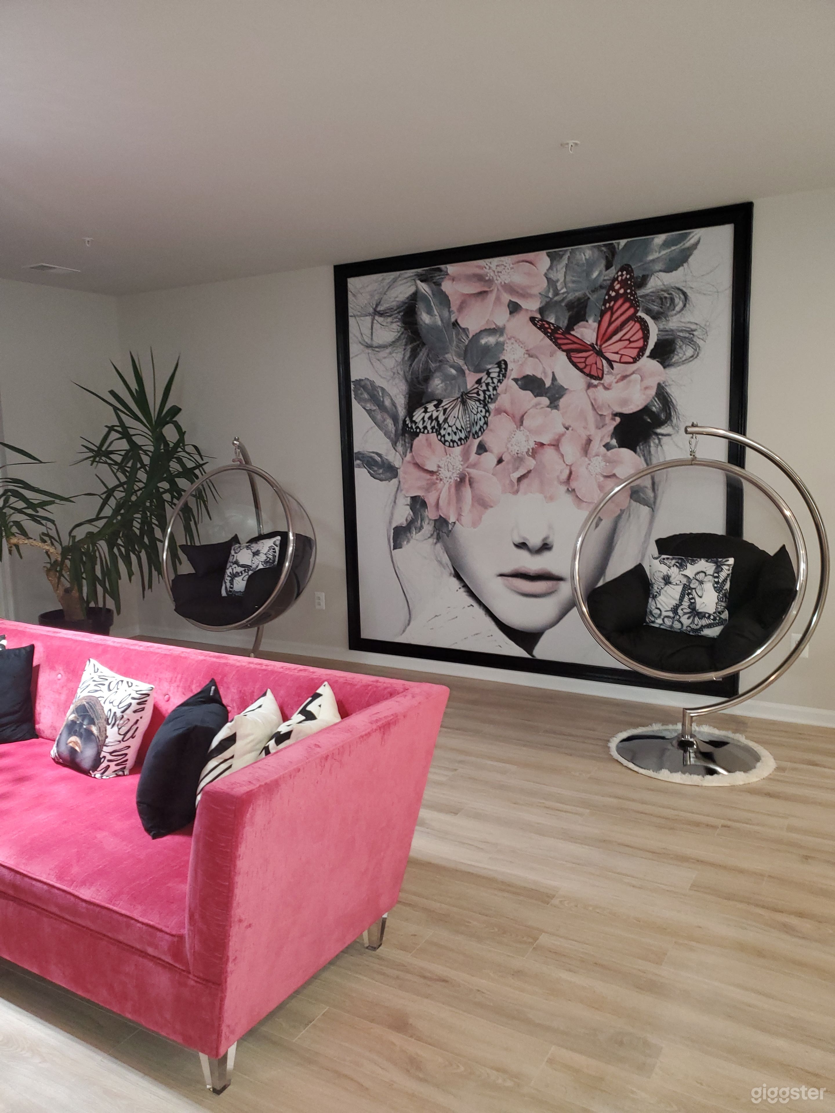 Living area with clear Bubble swing chairs &amp; mural