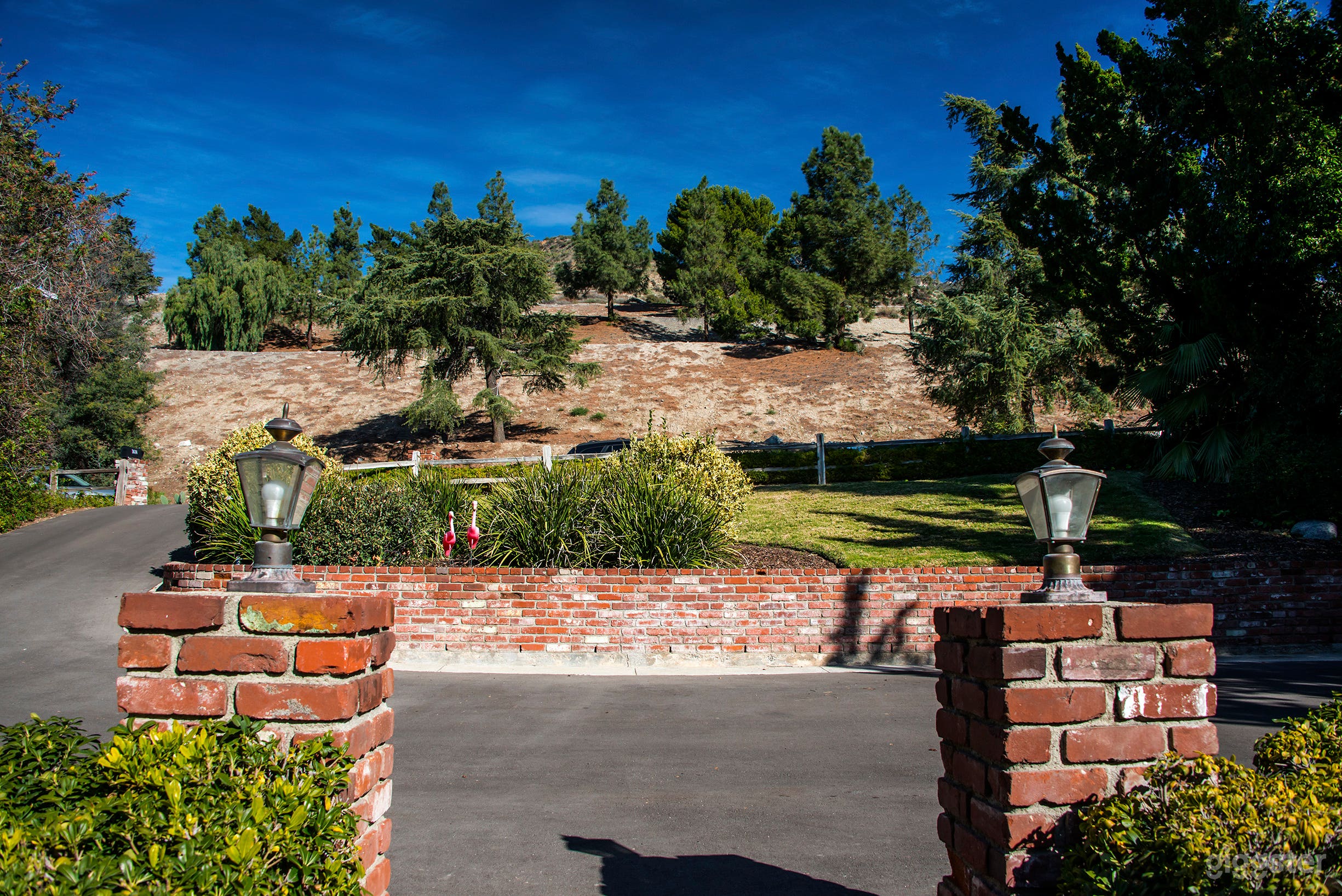 Looking from front of house to street.  County flood control across the street then the mountains.
