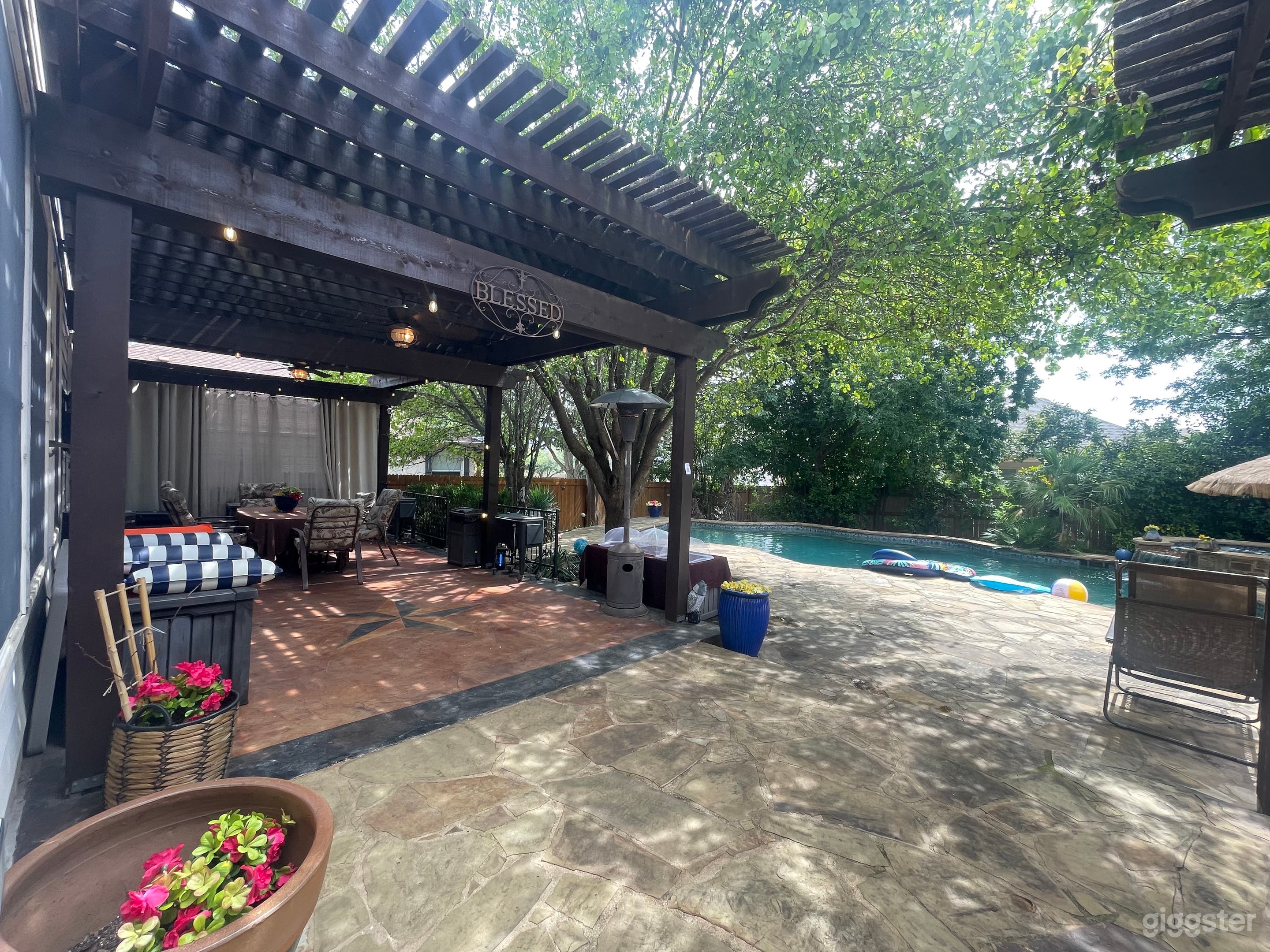 Large shaded pergola with 2 ceiling fans.