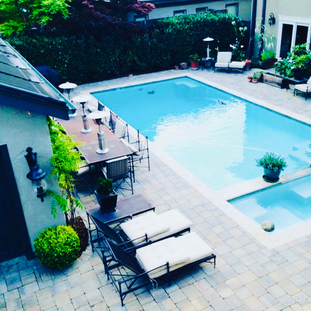 Pool and spa next to man cave and cabana and changing room. Outdoor shower. 