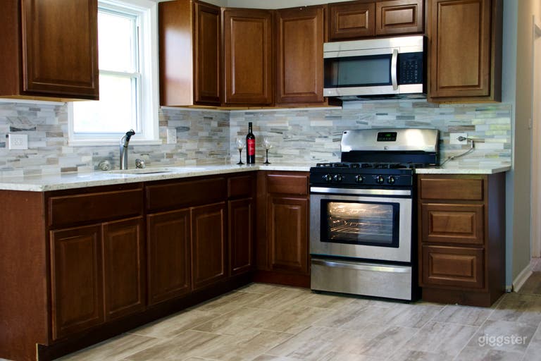  Spacious L-Shaped Kitchen with granite counters and wood cabinets.  