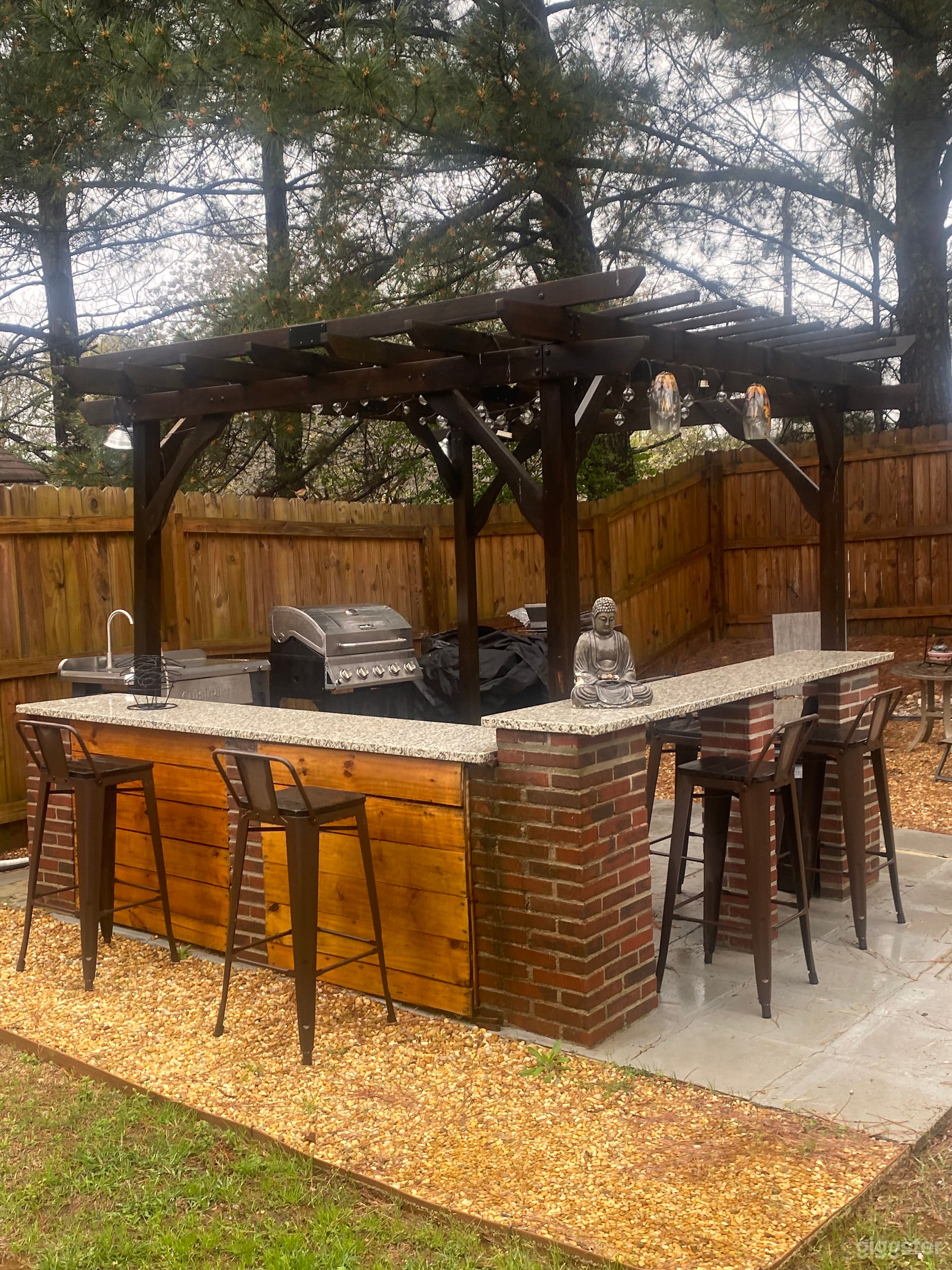 Granite countertops, 3 grills, water, warm lighting. 