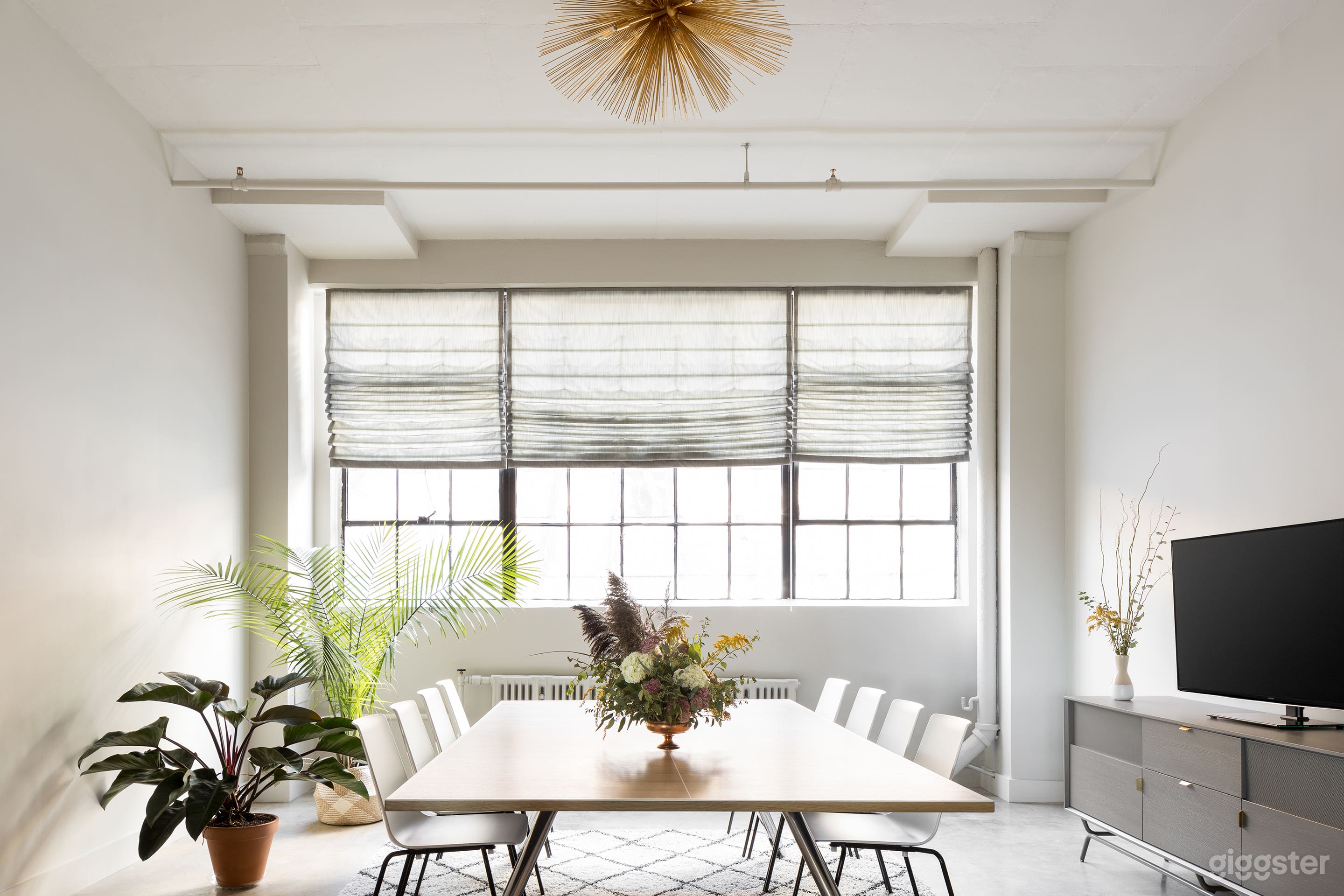The Conference Room is full of natural light, and a conference table that converts to a ping pong table