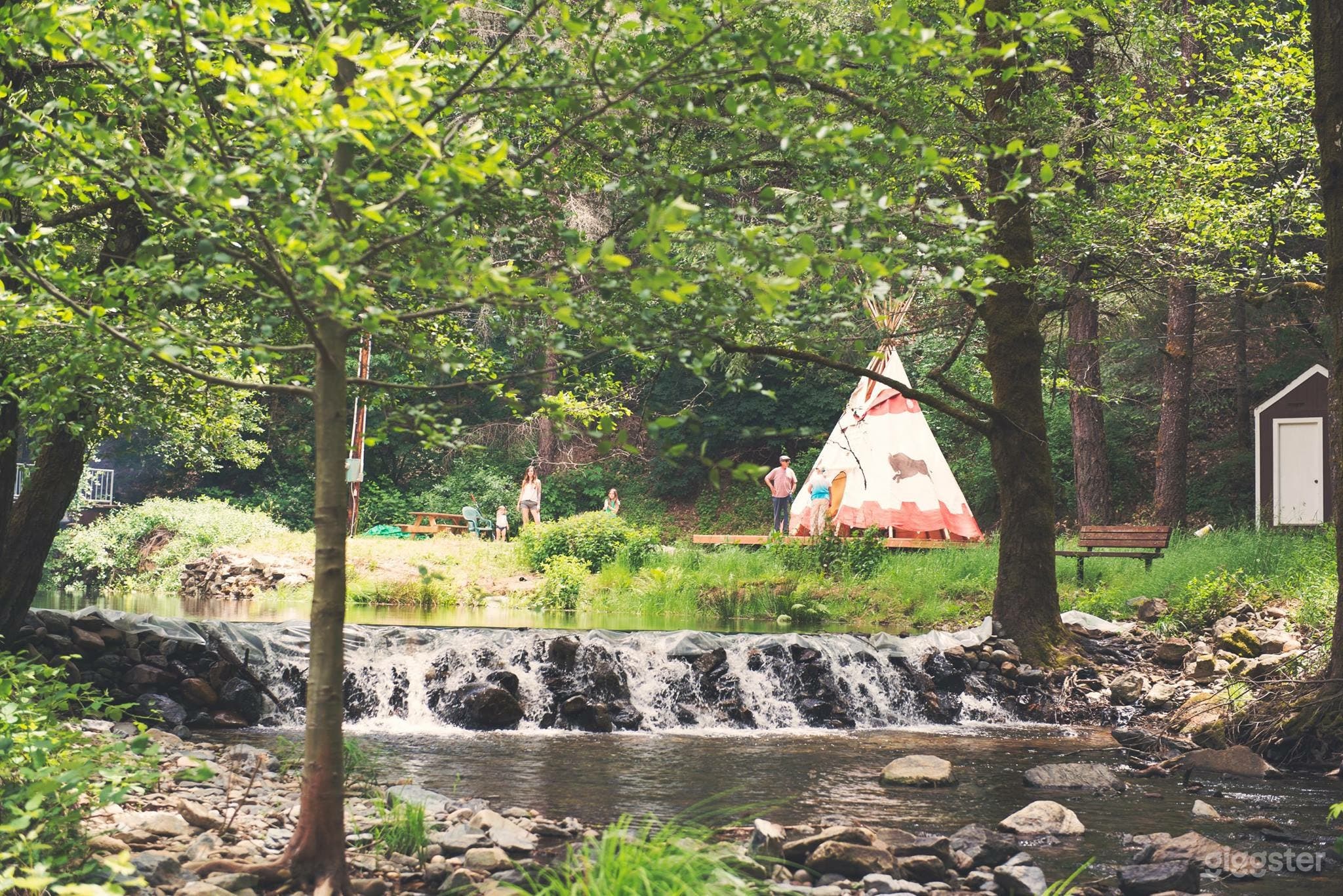 Creek with teepee in background