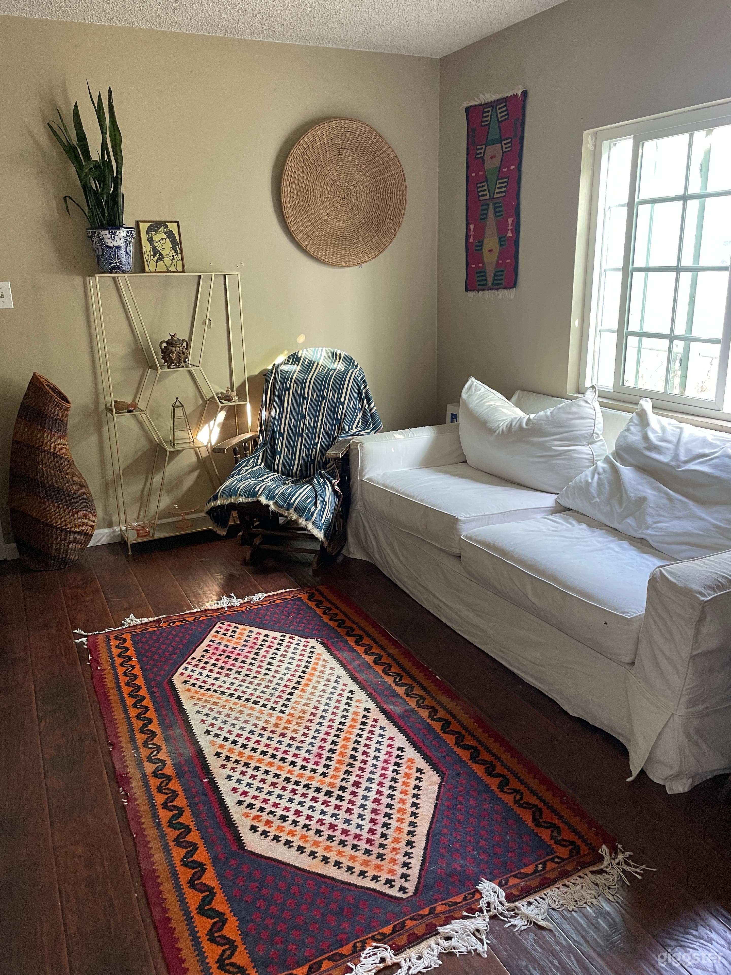 Den with additional seating and a television, can be used as dressing room, makeup room or green room.