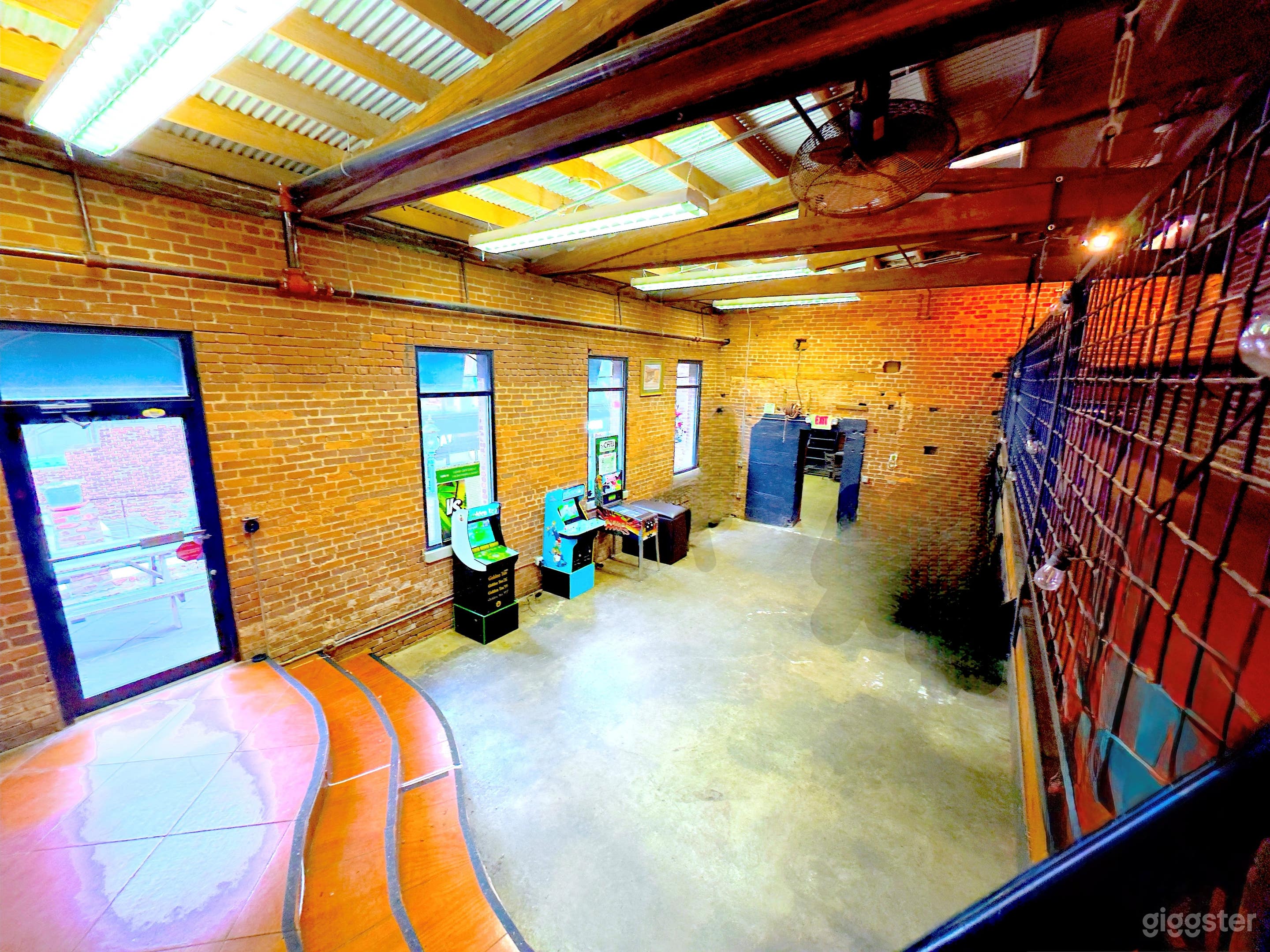 Cozy brick-lined lounge with skylights and signature lighting—perfect for gatherings, showcases, and social events.