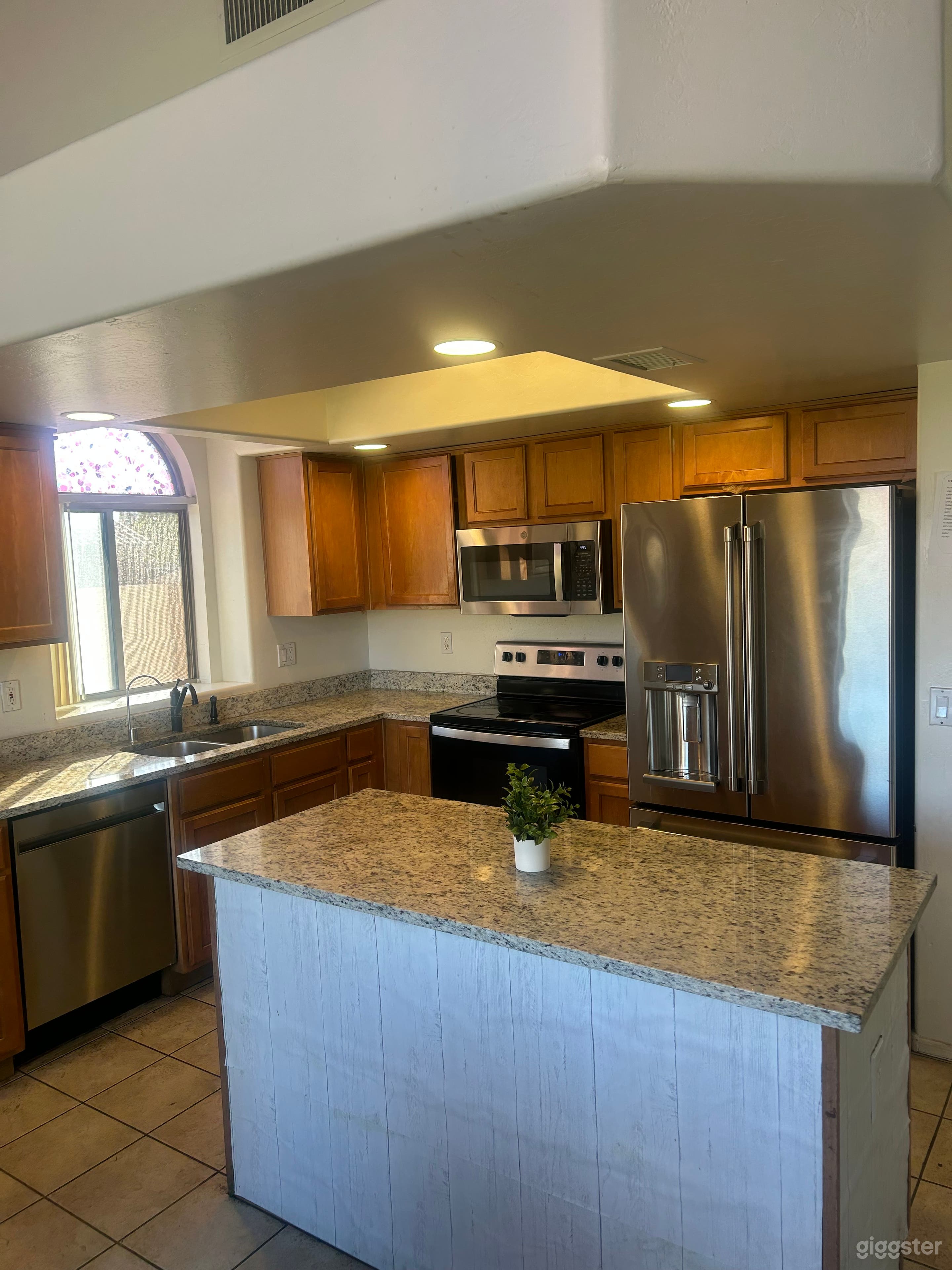 Luxury Chef’s Kitchen with a premium marble island and 86-inch screen. Perfect for professional cooking shows and food photography.